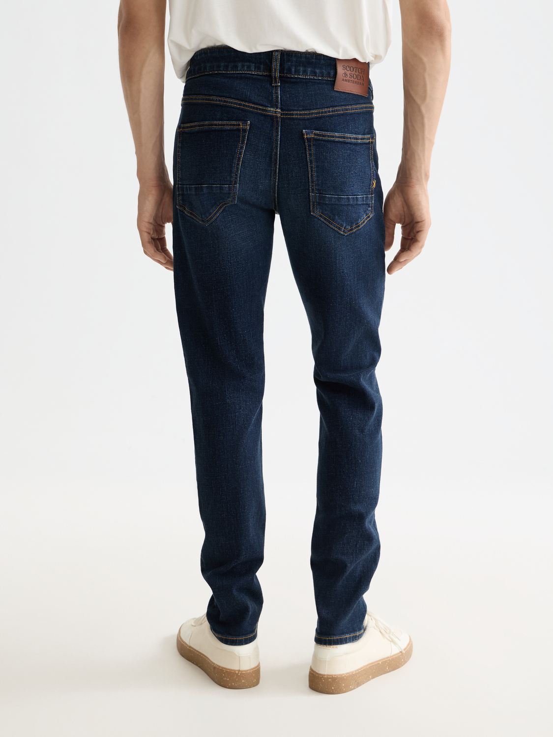 Dark blue Scotch & SODA skinny-fit denim jeans with back pockets, showcasing a sleek, fitted silhouette.