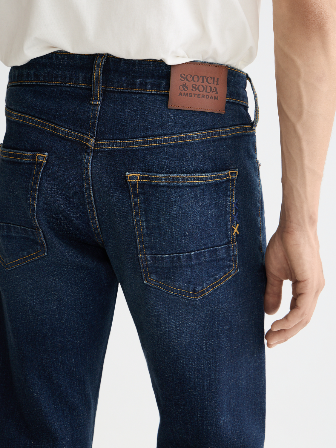 Scotch & Soda Ralston slim-fit denim jeans shown in classic blue with five-pocket design and modern fit.
