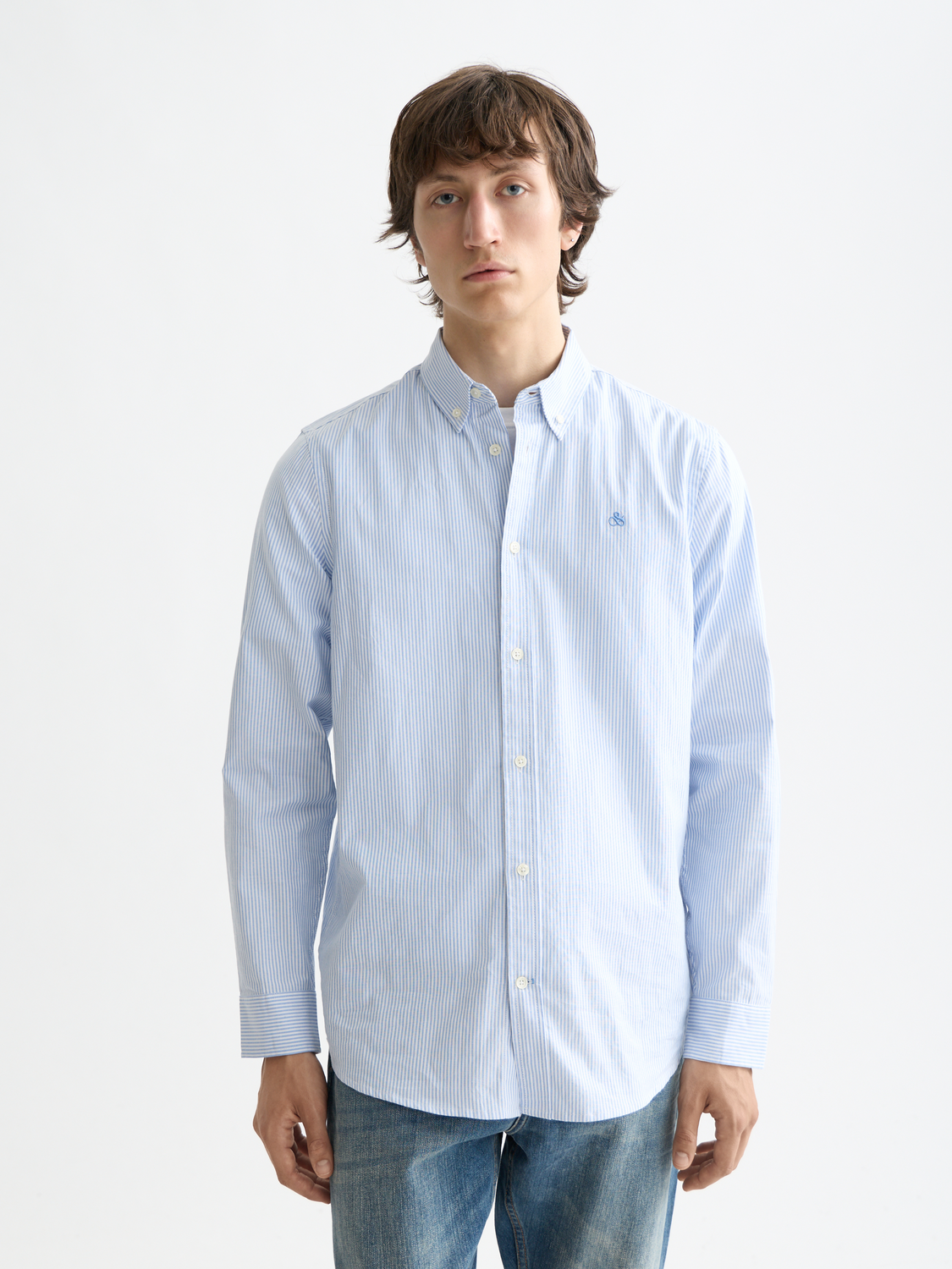 Long sleeve striped oxford shirt by Scotch & Soda, featuring classic design and button-down collar on a white and blue striped fabric.