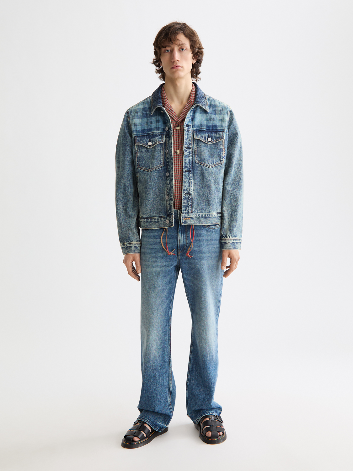 Light blue Scotch & Soda denim trucker jacket with classic collar and button front, shown on a model.