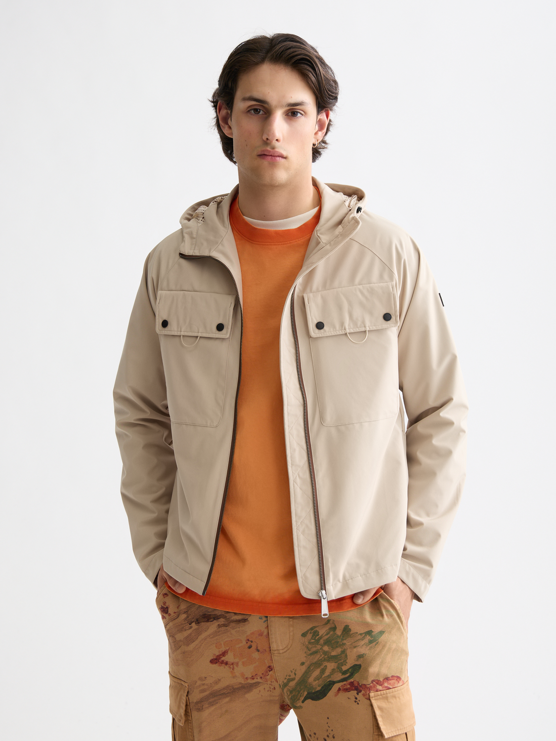 SCOTCH & SODA hooded softshell jacket in dark gray with front zipper and adjustable hood, shown on a model.