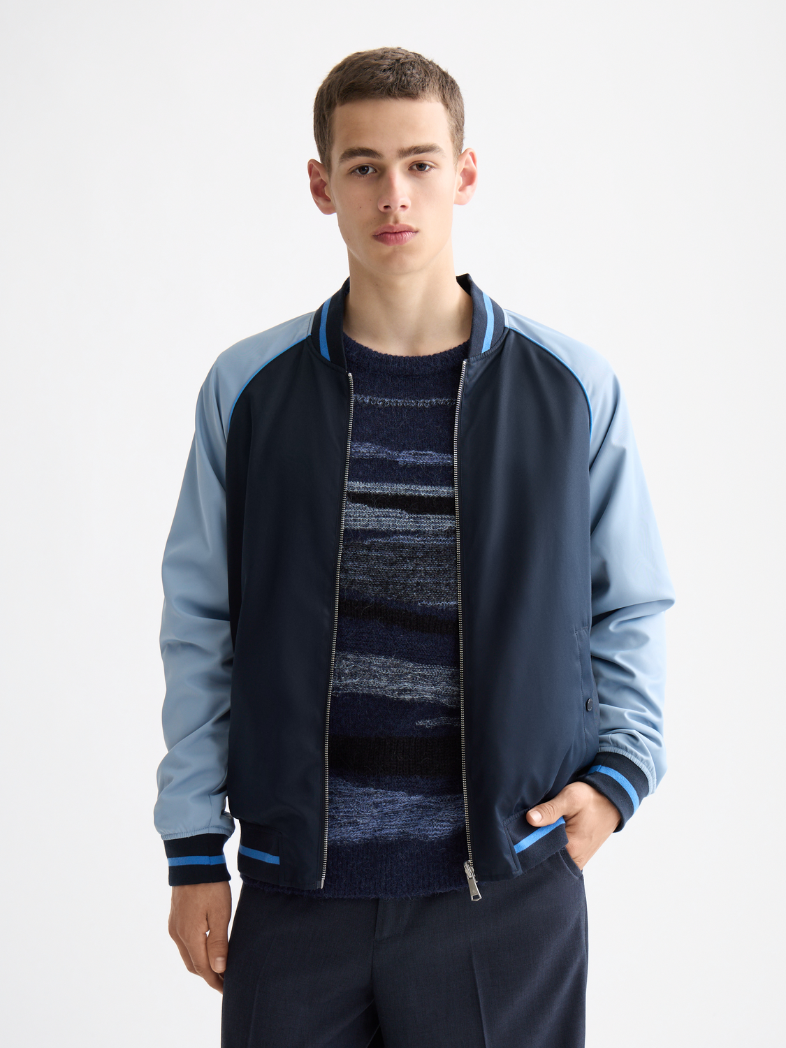 Reversible Scotch & Soda bomber jacket in stylish black and patterned fabric, shown with front view and collar detail.