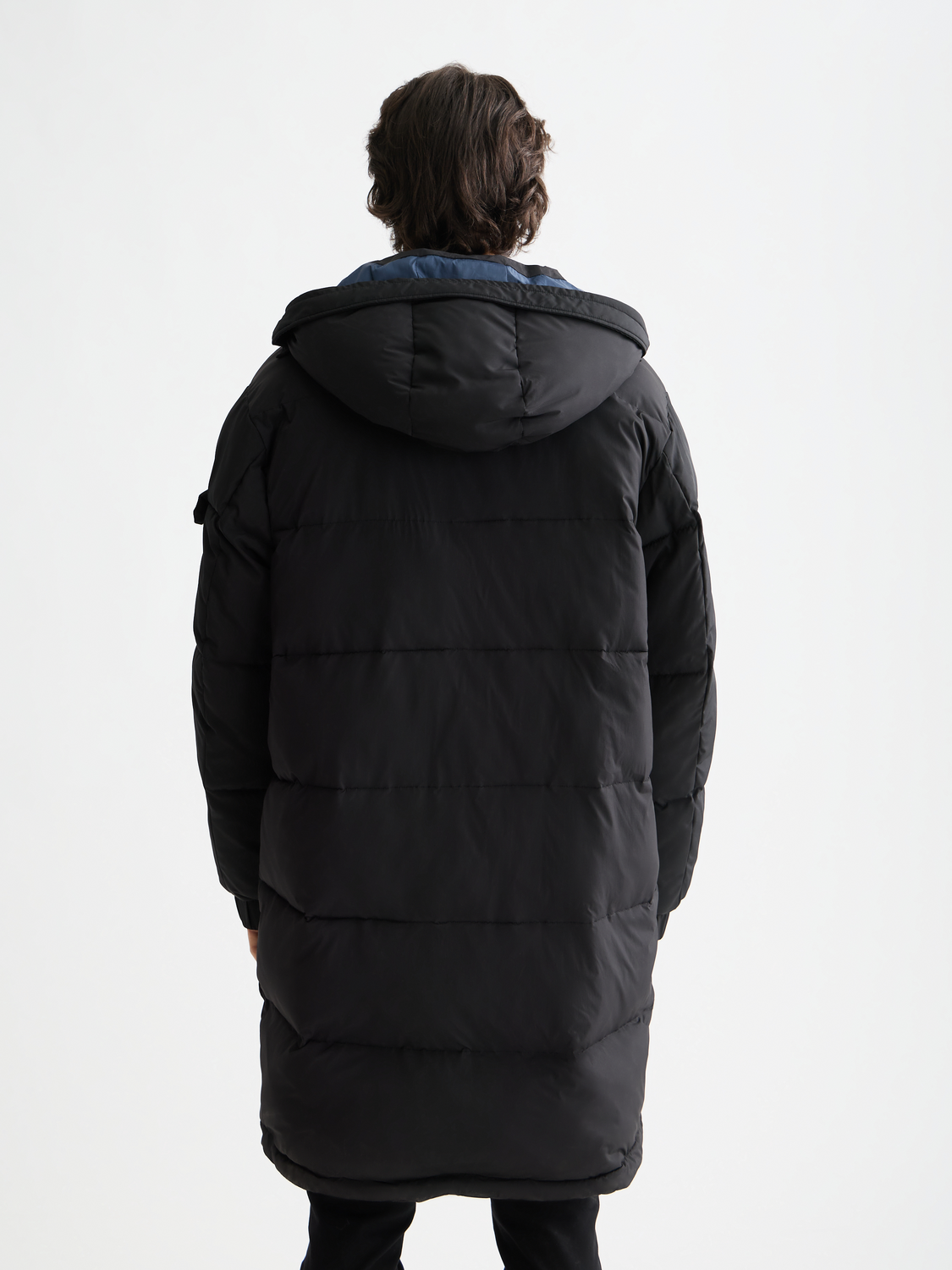 Long puffer jacket by Scotch & Soda, showcasing a warm, quilted design with a high collar and stylish silhouette.
