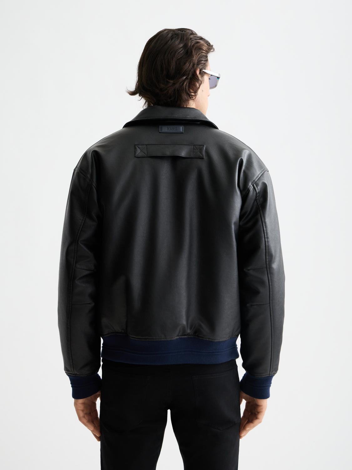 Scotch & Soda faux leather puffer jacket showing a back view with quilted design and high collar, stylish winter outerwear.