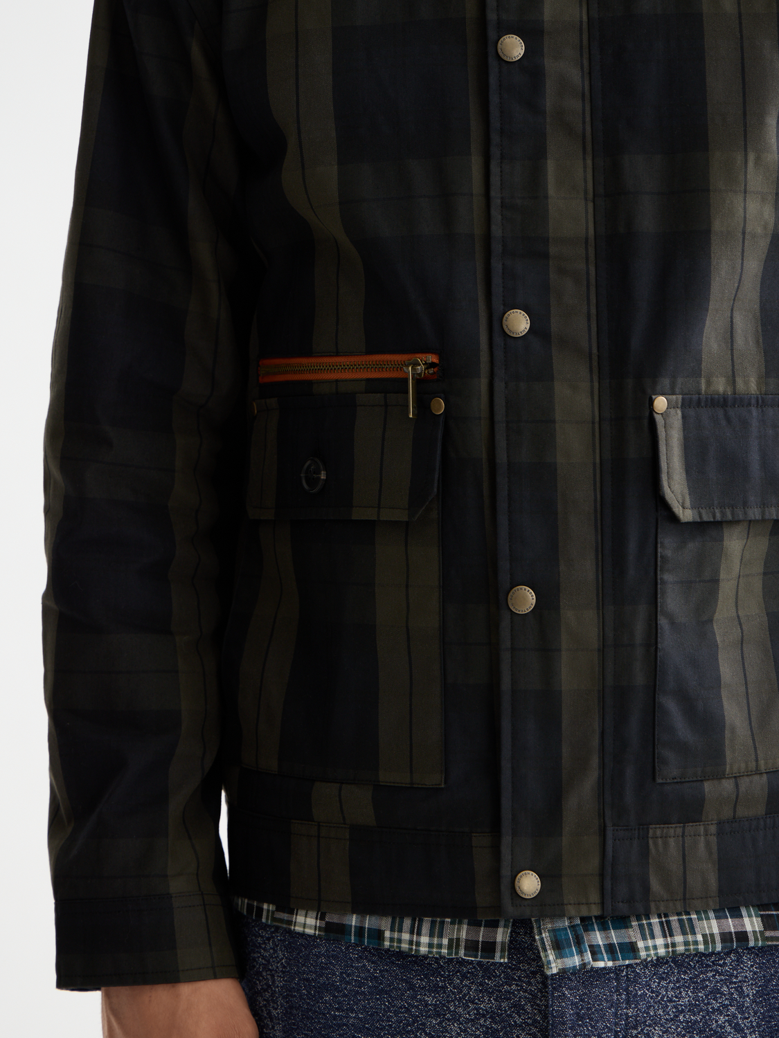 Scotch & Soda wax cotton jacket with a classic collar, front buttons, and durable fabric, displayed on a hanger.