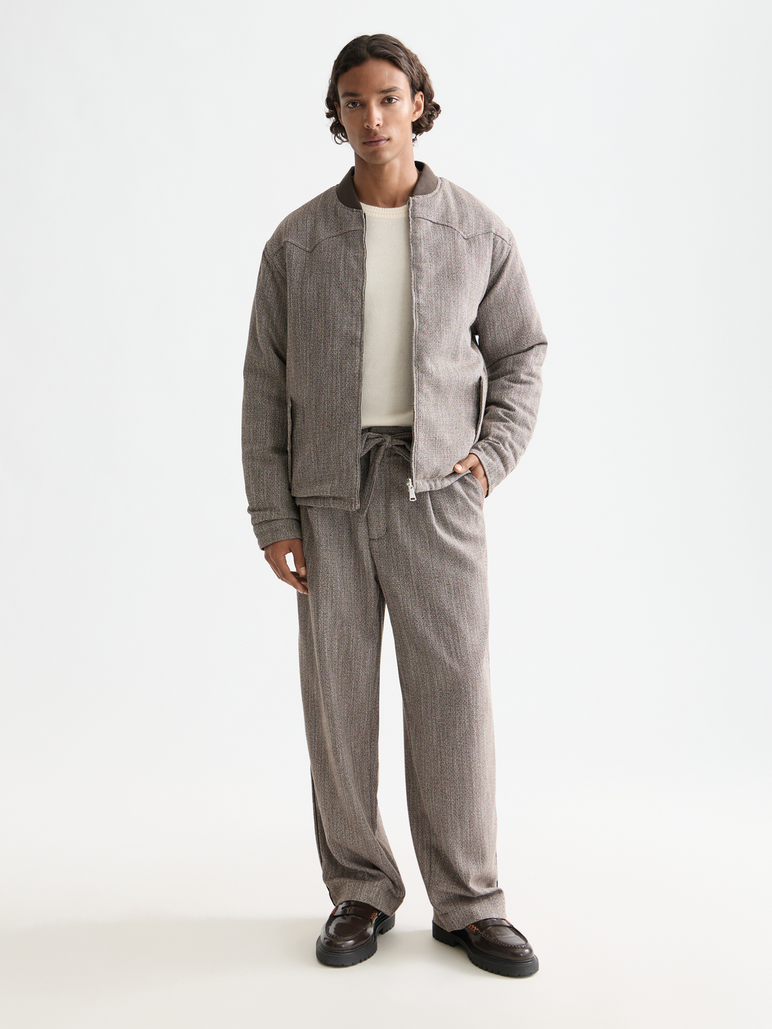 Reversible Scotch & Soda bomber jacket showing both solid and patterned sides, with ribbed cuffs and a front zipper.
