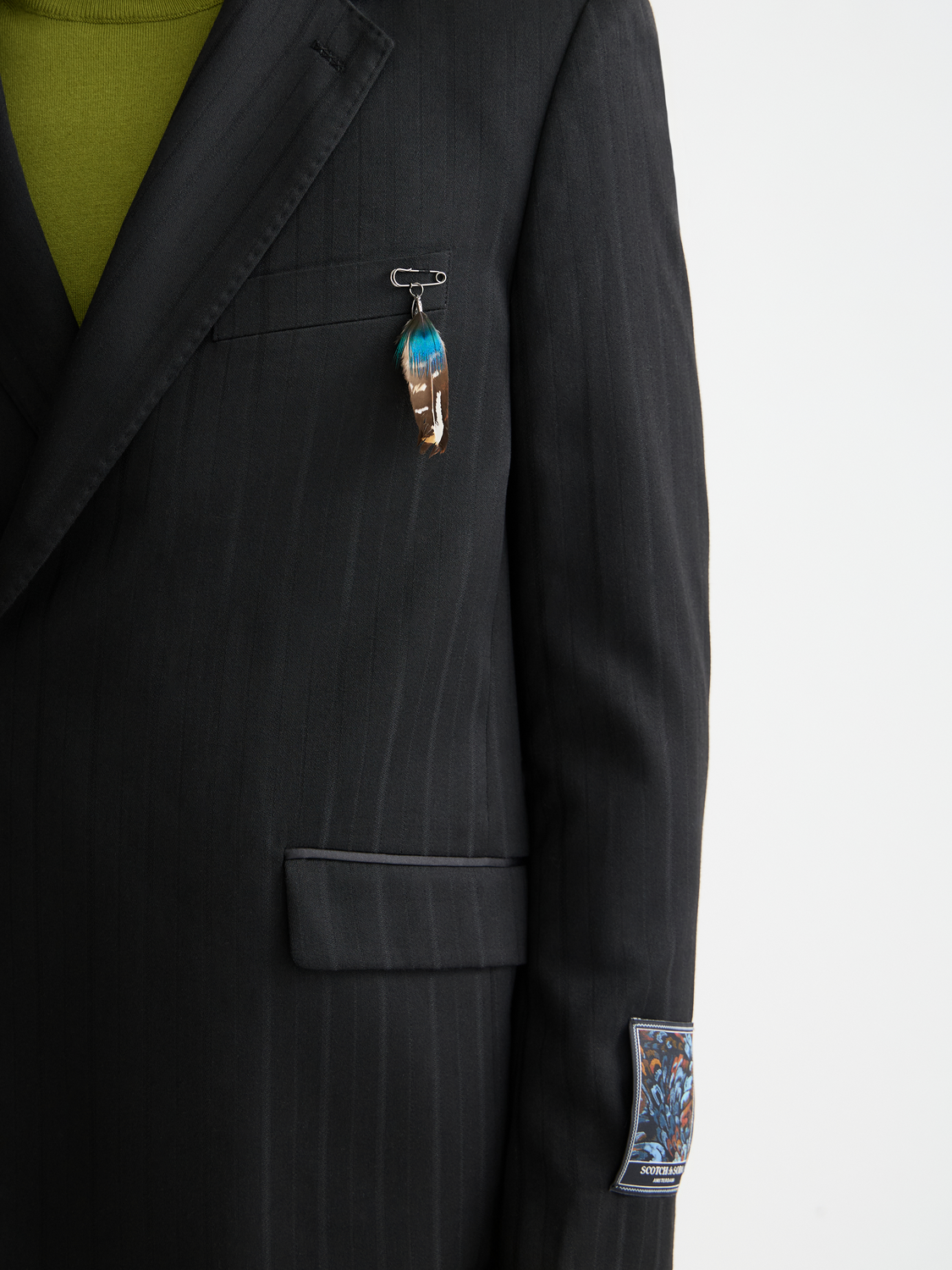 SCOTCH & SODA double-breasted blazer in navy, featuring peak lapels and button closure, displayed on a hanger.