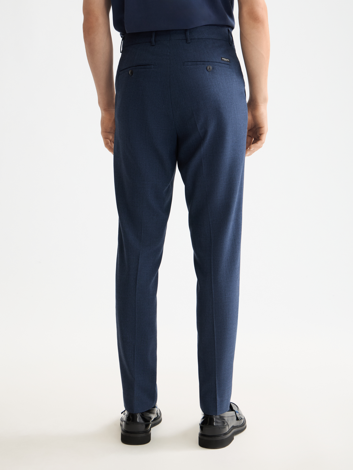 Scotch & Soda Irving tapered chinos pants in dark color, back view showing tailored fit and pocket details.