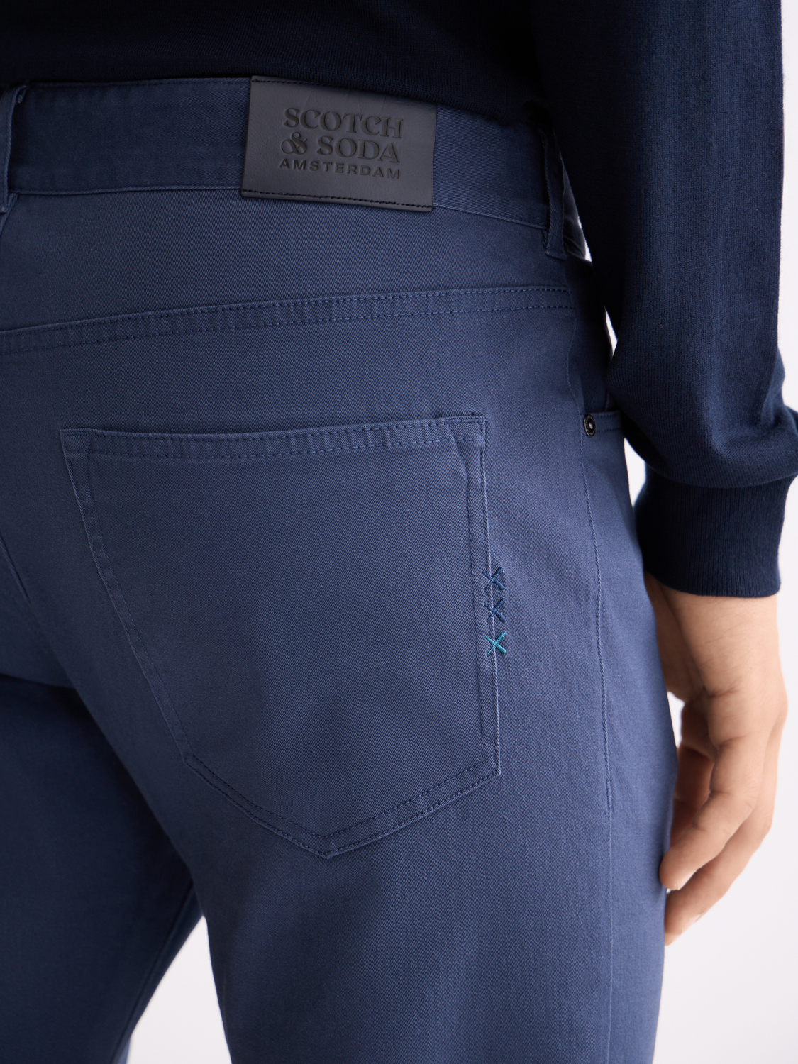 Scotch & Soda Ralston slim-fit 5-pocket pants in dark denim, showing the front view with pockets and stitching details.