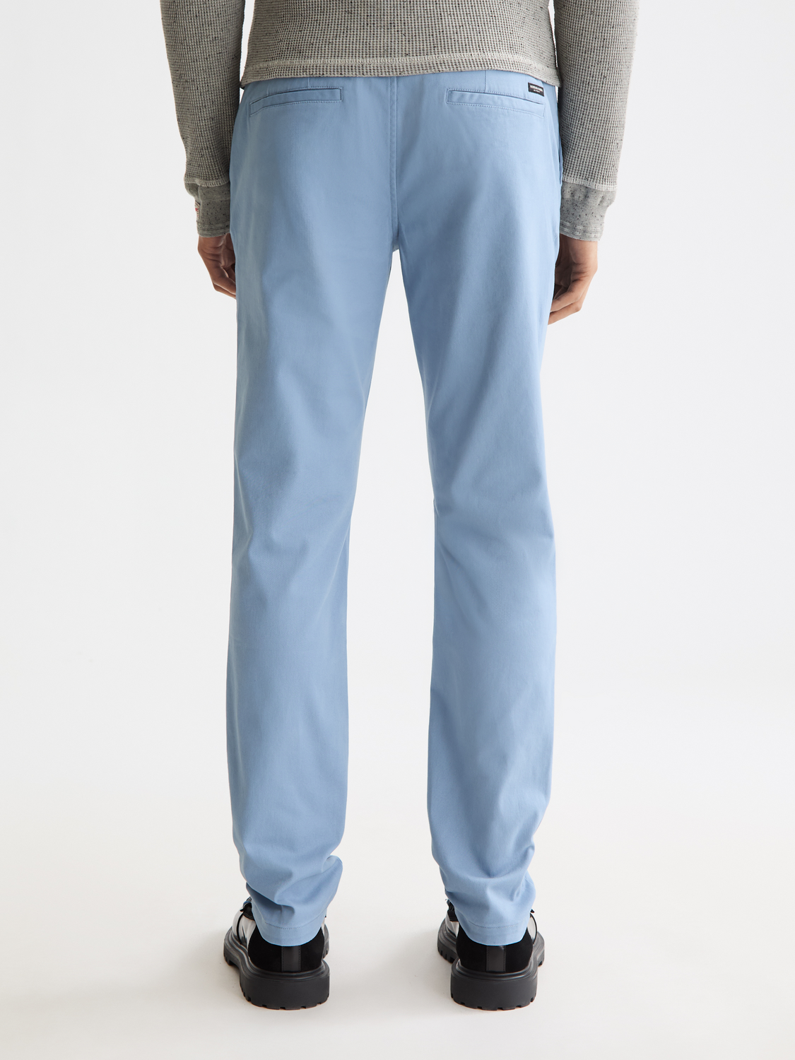 SCOTCH & SODA Mott slim-fit chinos pants in a dark color, shown from the back view with a tailored fit and back pockets.