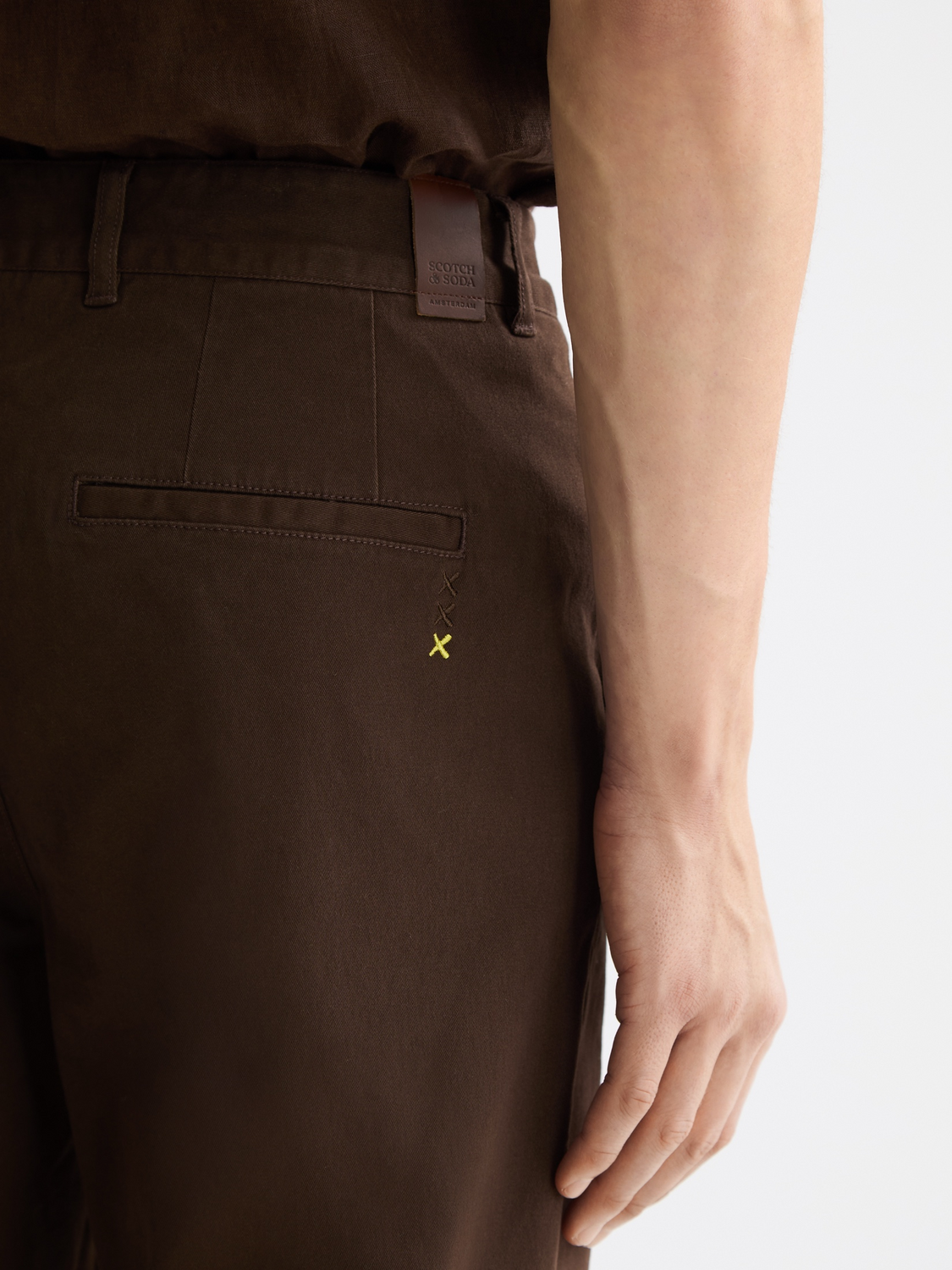 Drift tapered chinos by Scotch & Soda, stylish pants with a modern fit, shown in a neutral color on a plain background.