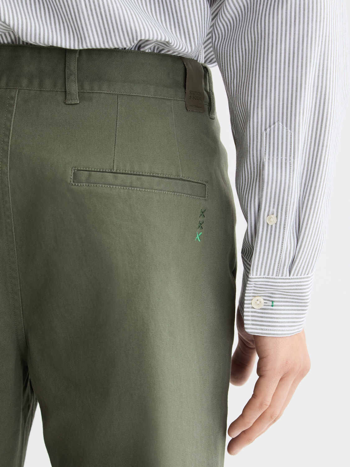 Drift tapered chinos by Scotch & Soda featuring slim fit design, in a neutral color, displayed on a model.