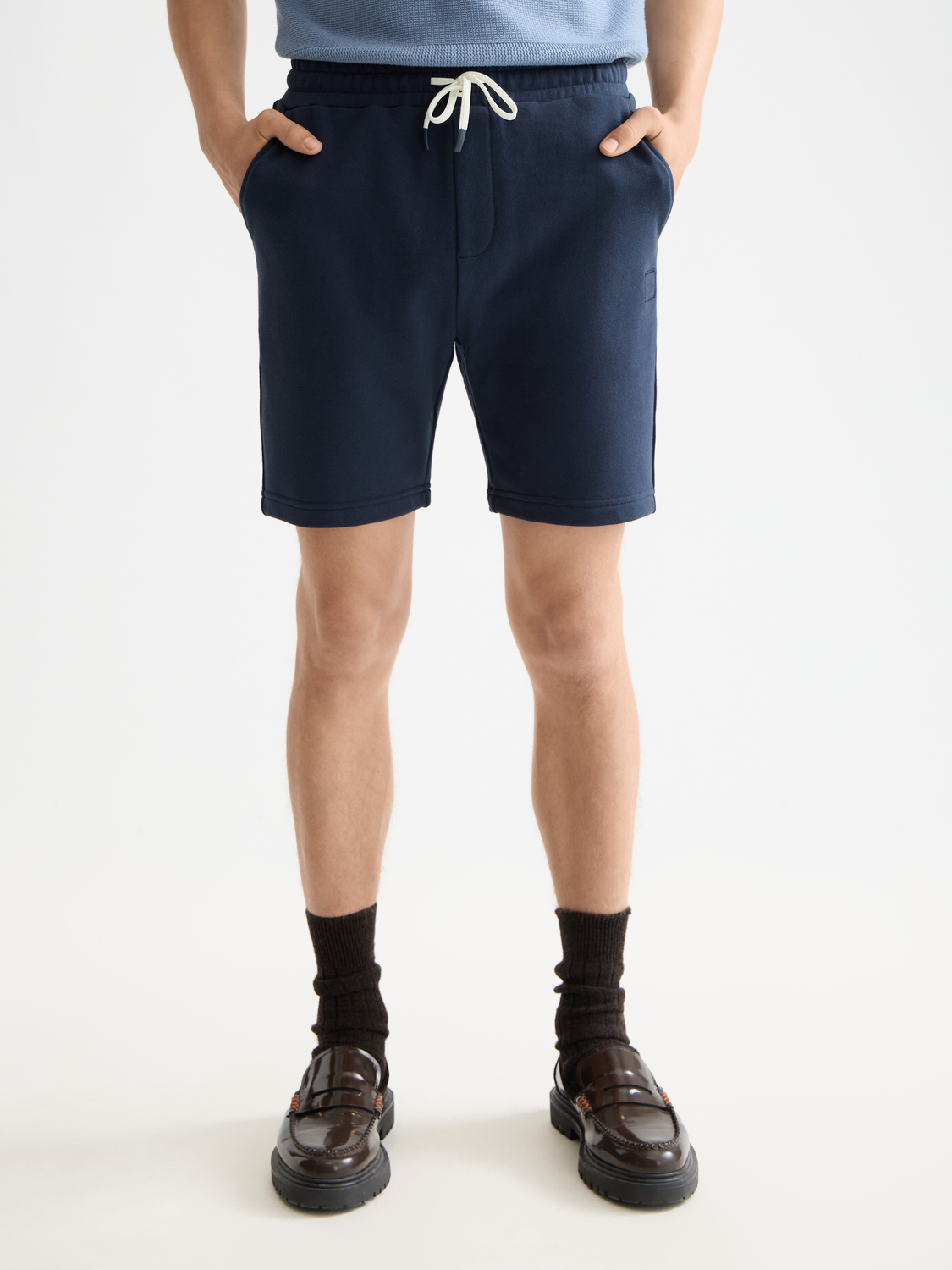 Light gray sweatshorts featuring a prominent Scotch & Soda logo badge on the front, casual and comfortable athletic shorts.