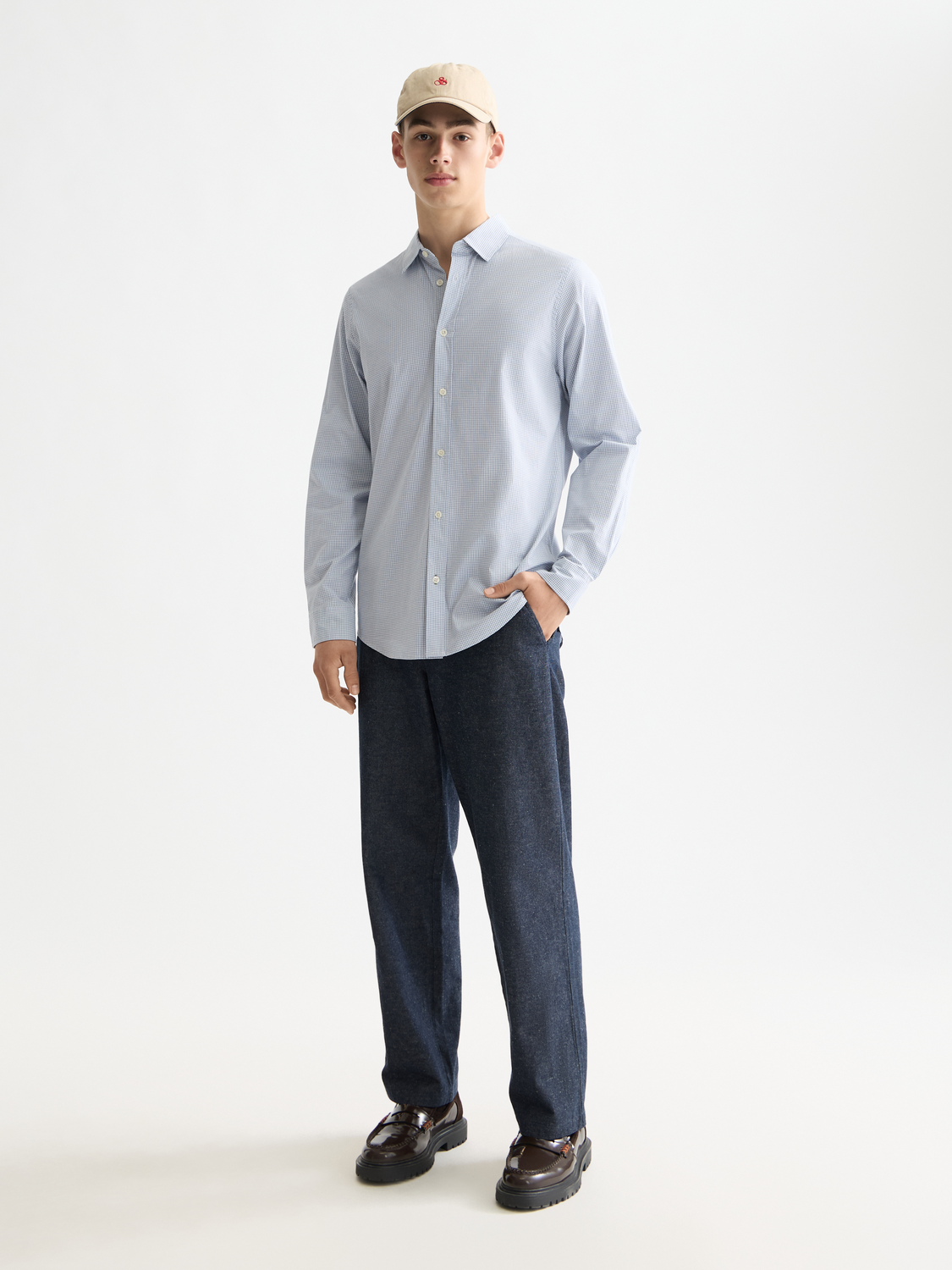 Long sleeve Scotch & Soda check poplin shirt with a classic pattern, shown hanging on a wooden hanger.