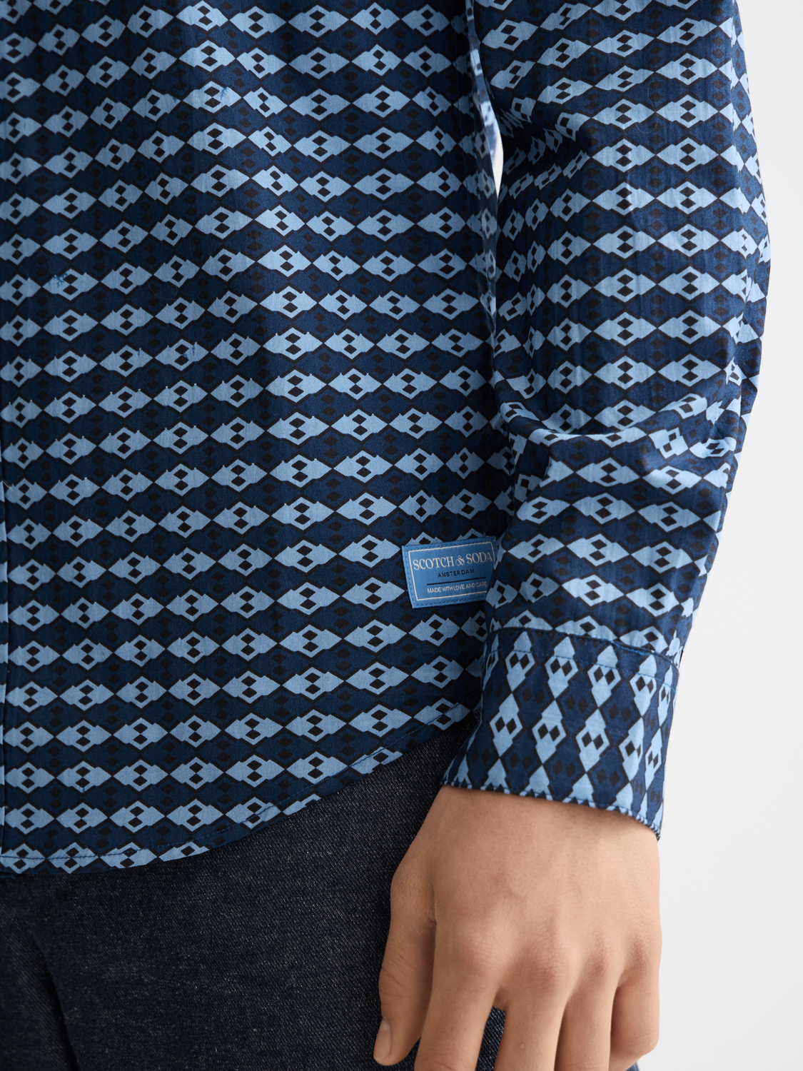 Long-sleeve printed shirt from Scotch & SODA featuring vibrant patterns and casual fit, displayed flat on a white background.