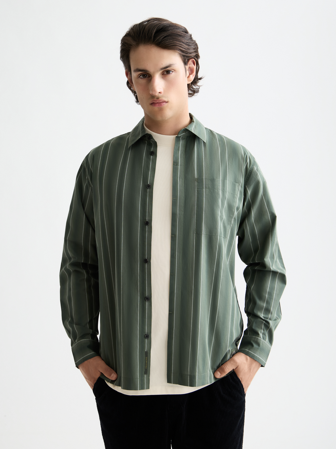 Long-sleeve striped shirt by Scotch & Soda, featuring a classic pattern and button-up front, displayed on a mannequin.