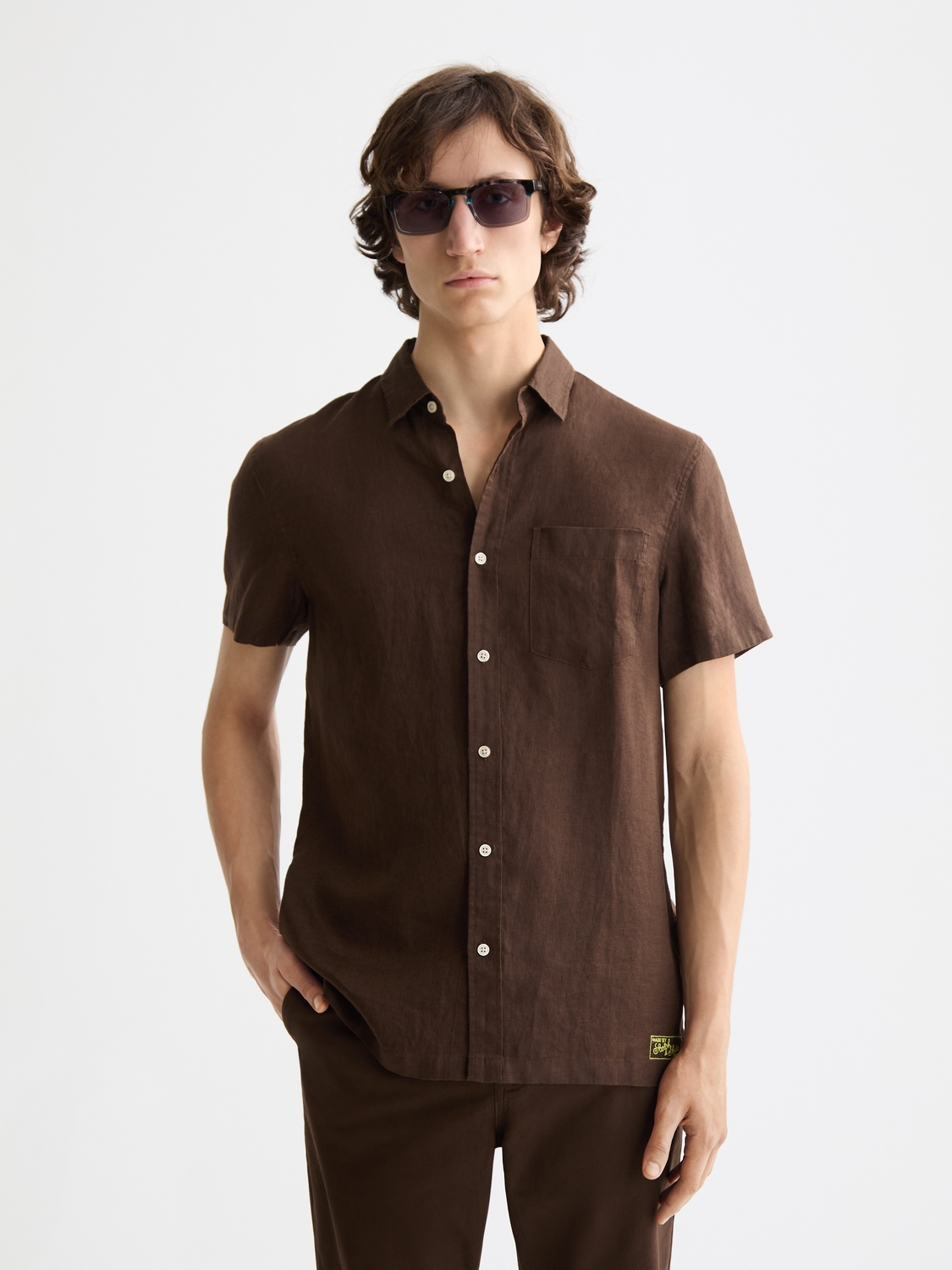 Short-sleeved linen shirt by Scotch & Soda, shown in a casual fit with a button-up front and lightweight fabric.