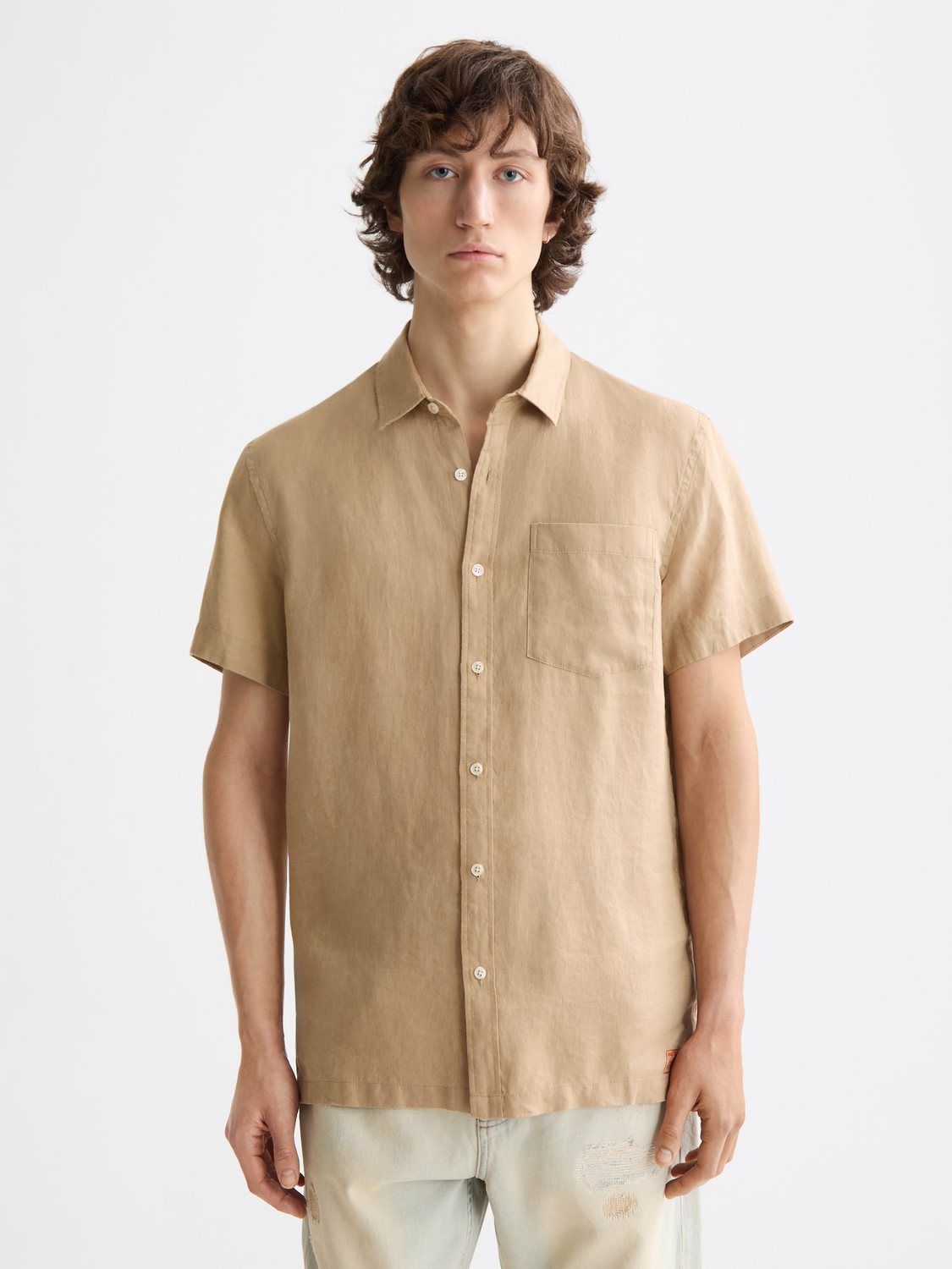 Light blue Scotch & Soda short-sleeved linen shirt with a classic collar and button front, displayed on a hanger.