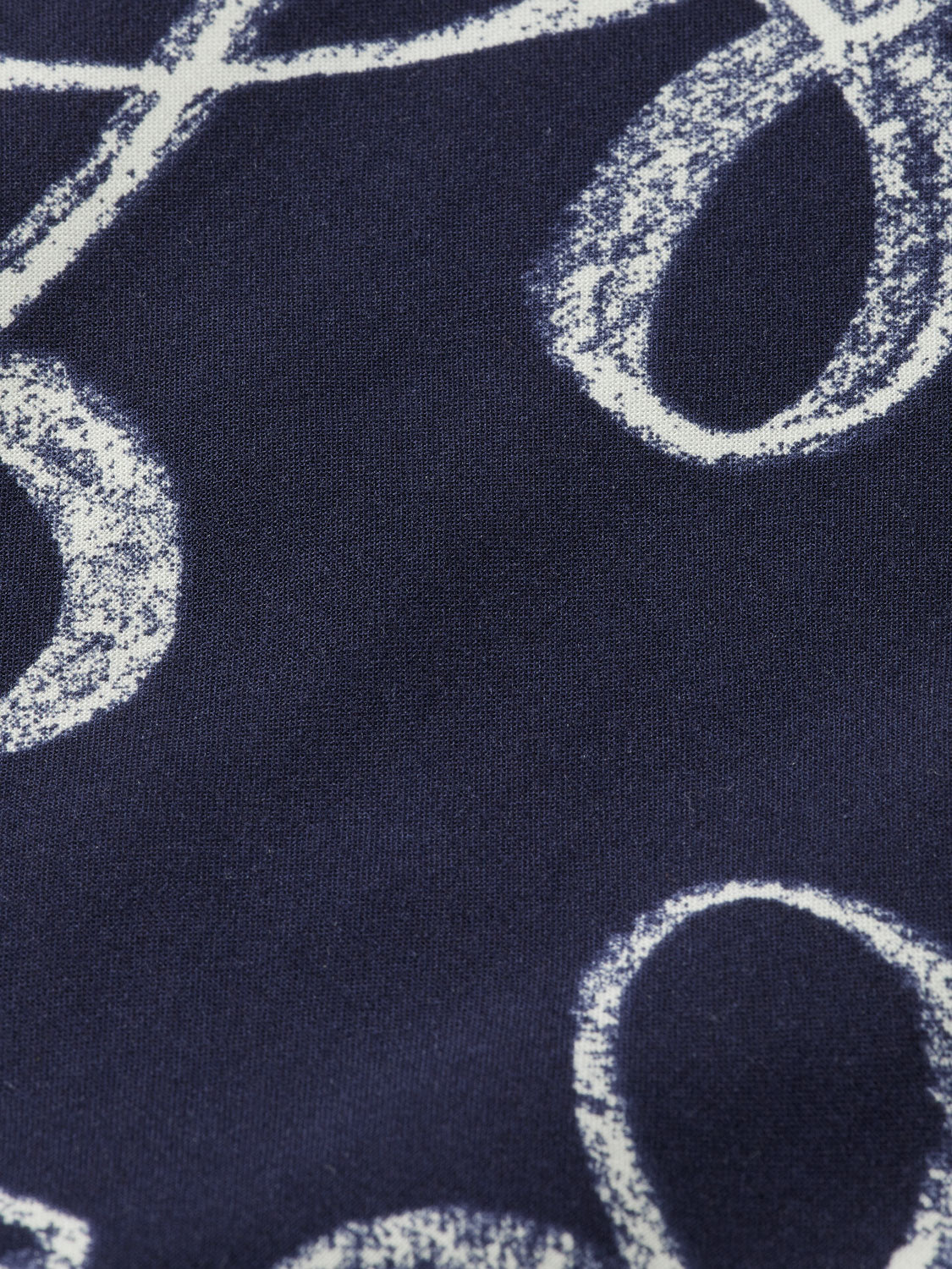 Printed short-sleeved shirt by Scotch & Soda featuring vibrant patterns and casual fit, displayed on a hanger.