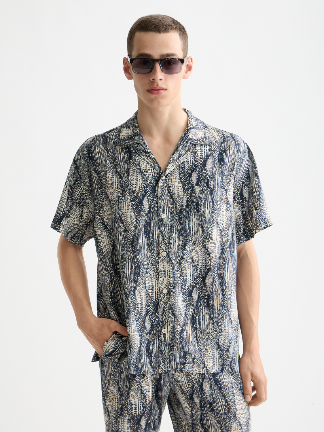 Printed short-sleeved Scotch & Soda shirt with vibrant pattern, lightweight fabric, and classic collar for casual summer style.