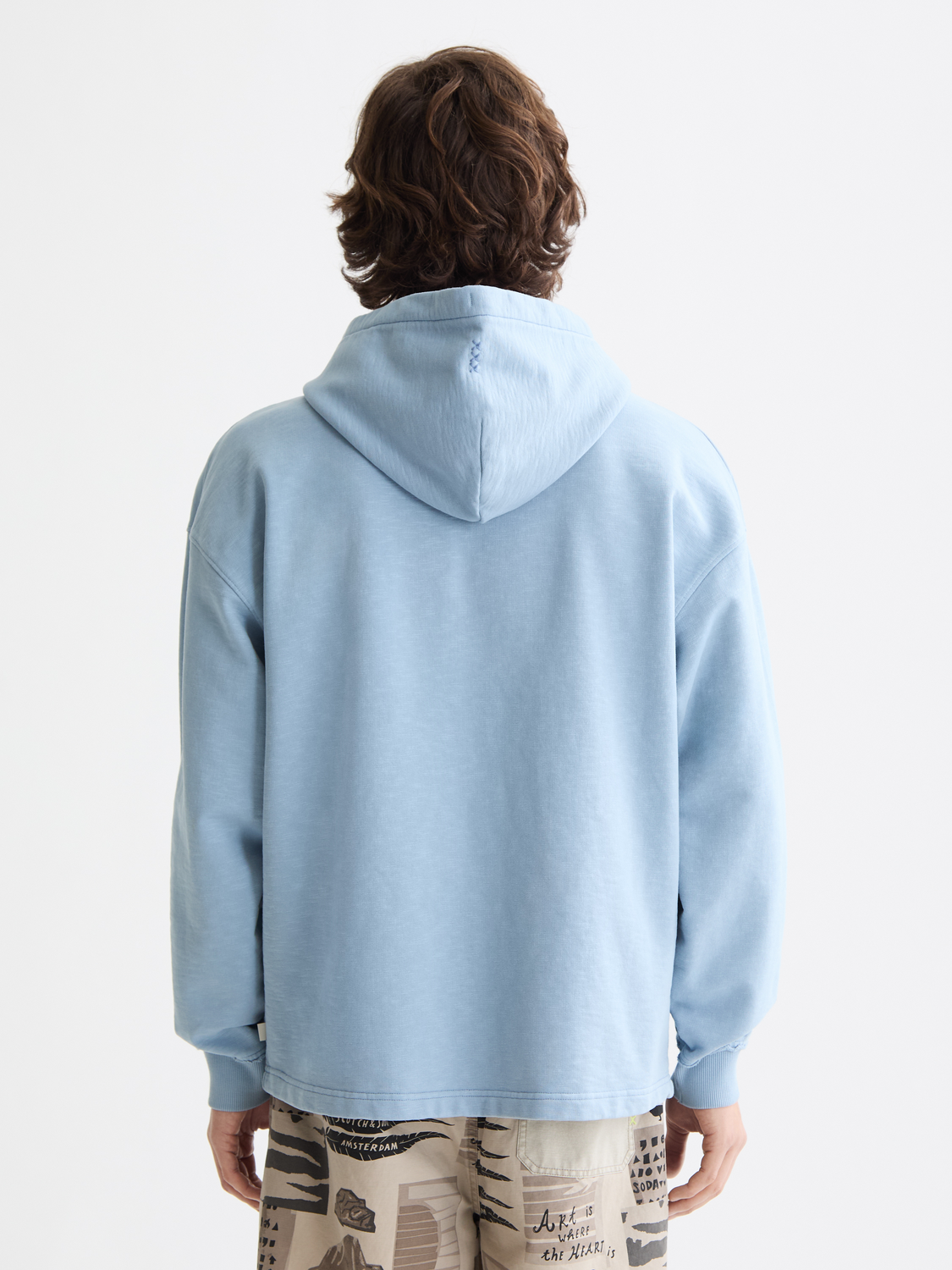 Dark gray garment-dyed hoodie from Scotch & Soda, featuring a relaxed fit and soft cotton fabric, shown from the back view.