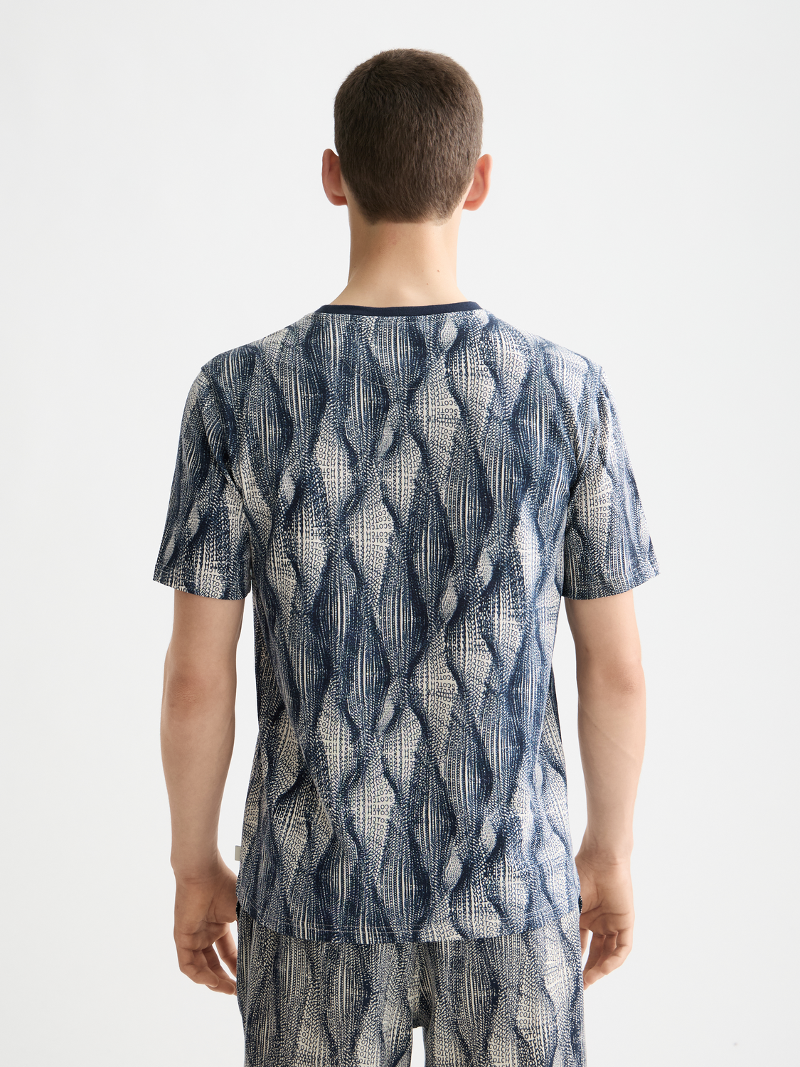 Printed SCOTCH & SODA short sleeve t-shirt with vibrant design on black fabric, displayed flat with visible neckline and sleeves.