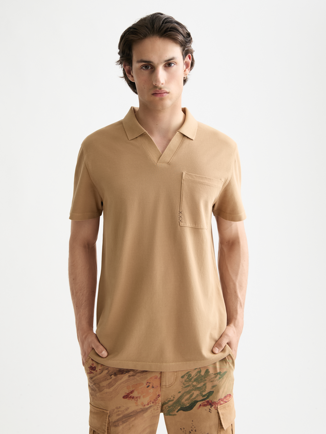 Light blue Scotch & Soda pique polo shirt with a classic collar and short sleeves, displayed on a plain background.