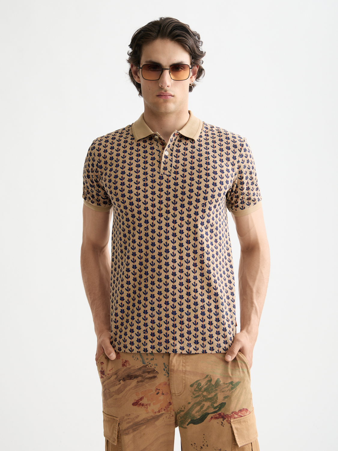 Printed Scotch & Soda polo shirt with colorful pattern, short sleeves, and classic collar, displayed flat on a white background.