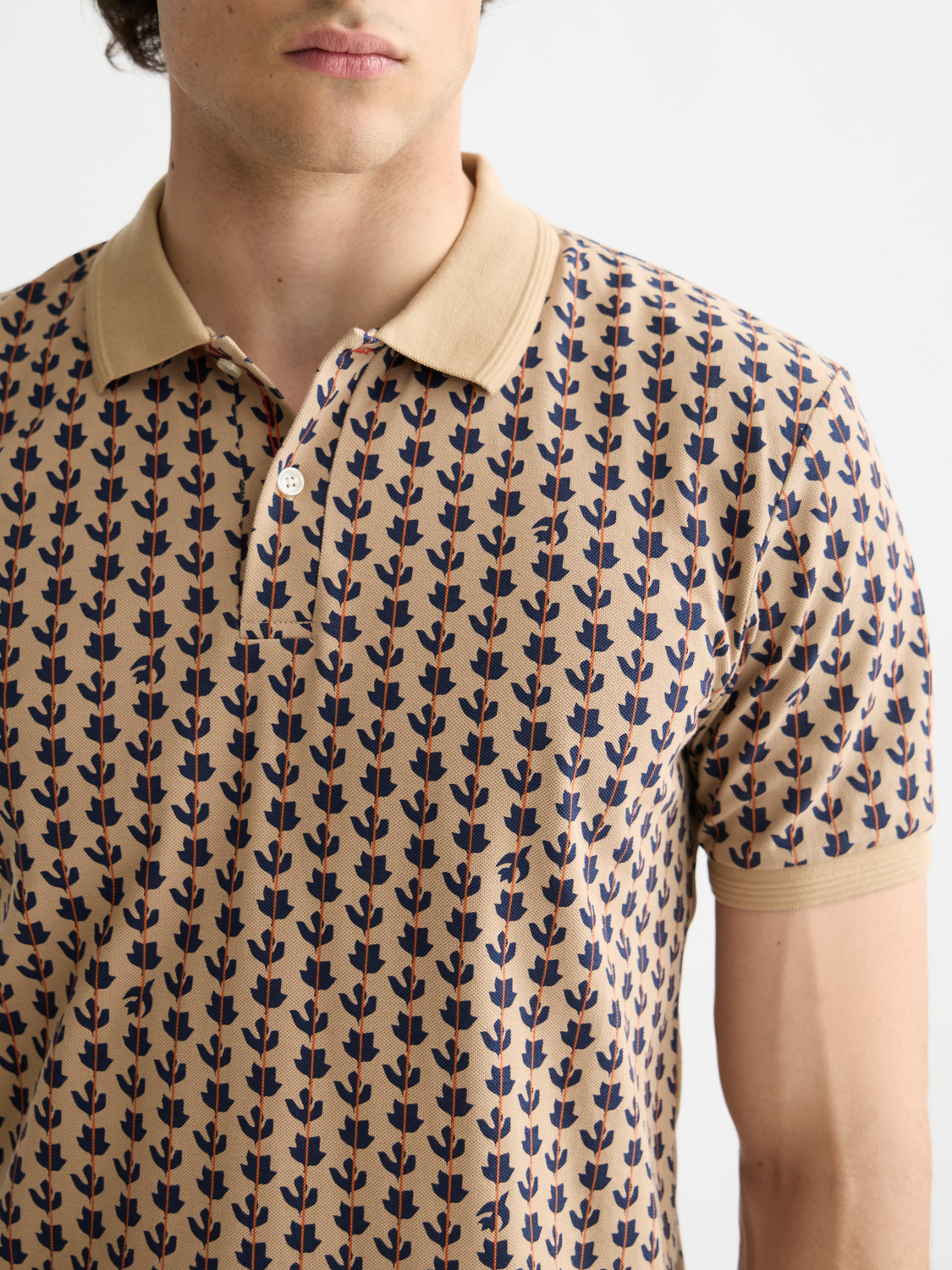 Printed Scotch & Soda polo shirt with colorful design, short sleeves, and classic collar for men's casual style.