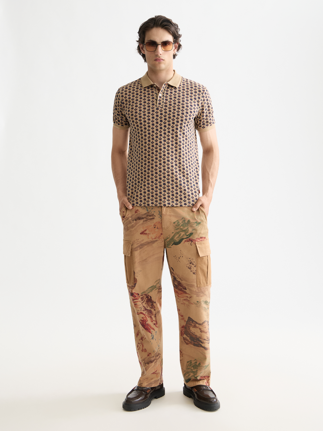 Men's printed polo shirt from Scotch & Soda featuring colorful design and classic fit, displayed on a plain background.
