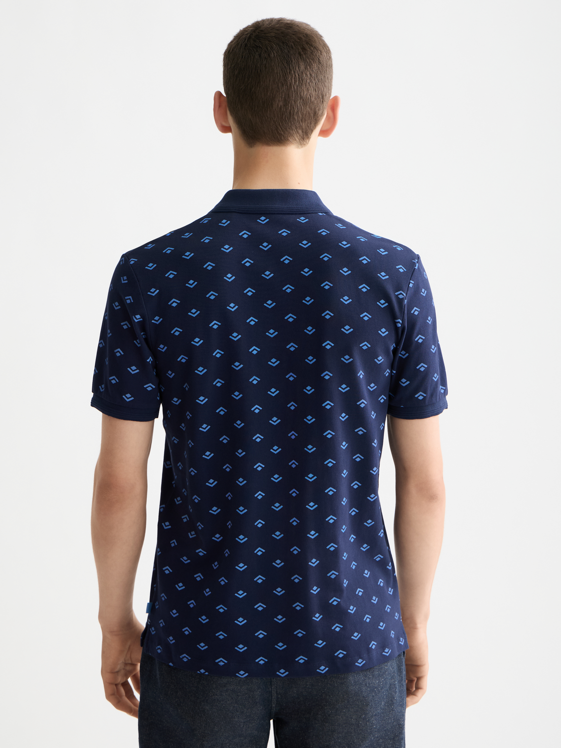 Printed polo shirt by Scotch & Soda featuring a vibrant pattern and classic collar, displayed on a neutral background.