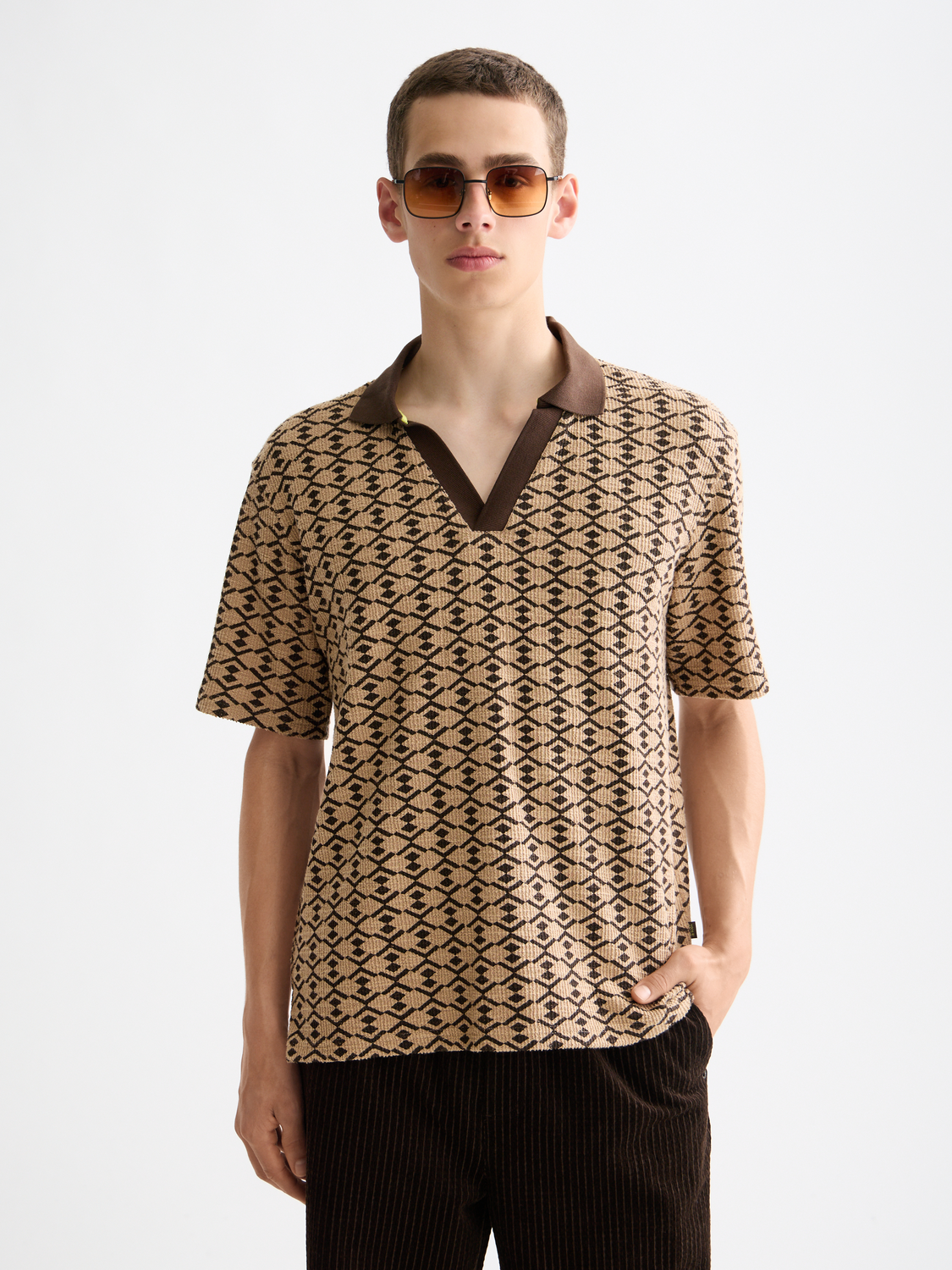 Scotch & Soda towelling polo shirt in coral color, showing the front view with a classic collar and short sleeves.
