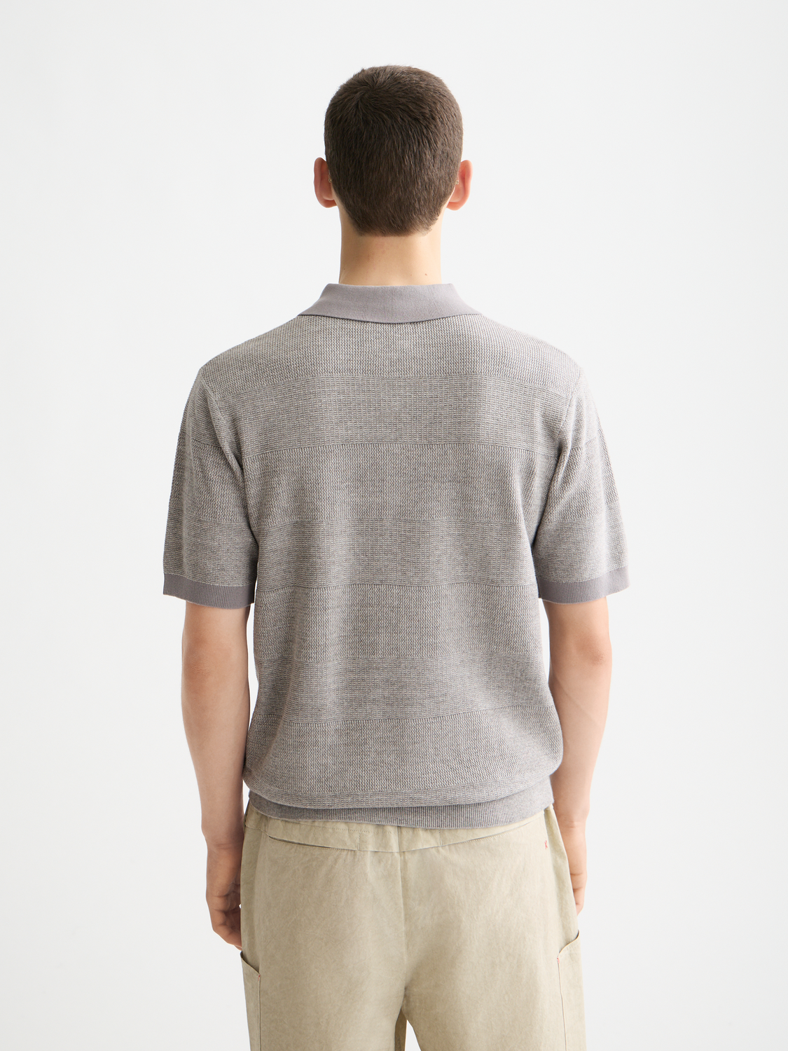 Knitted tonal striped polo shirt from Scotch & Soda featuring a classic collar and short sleeves.