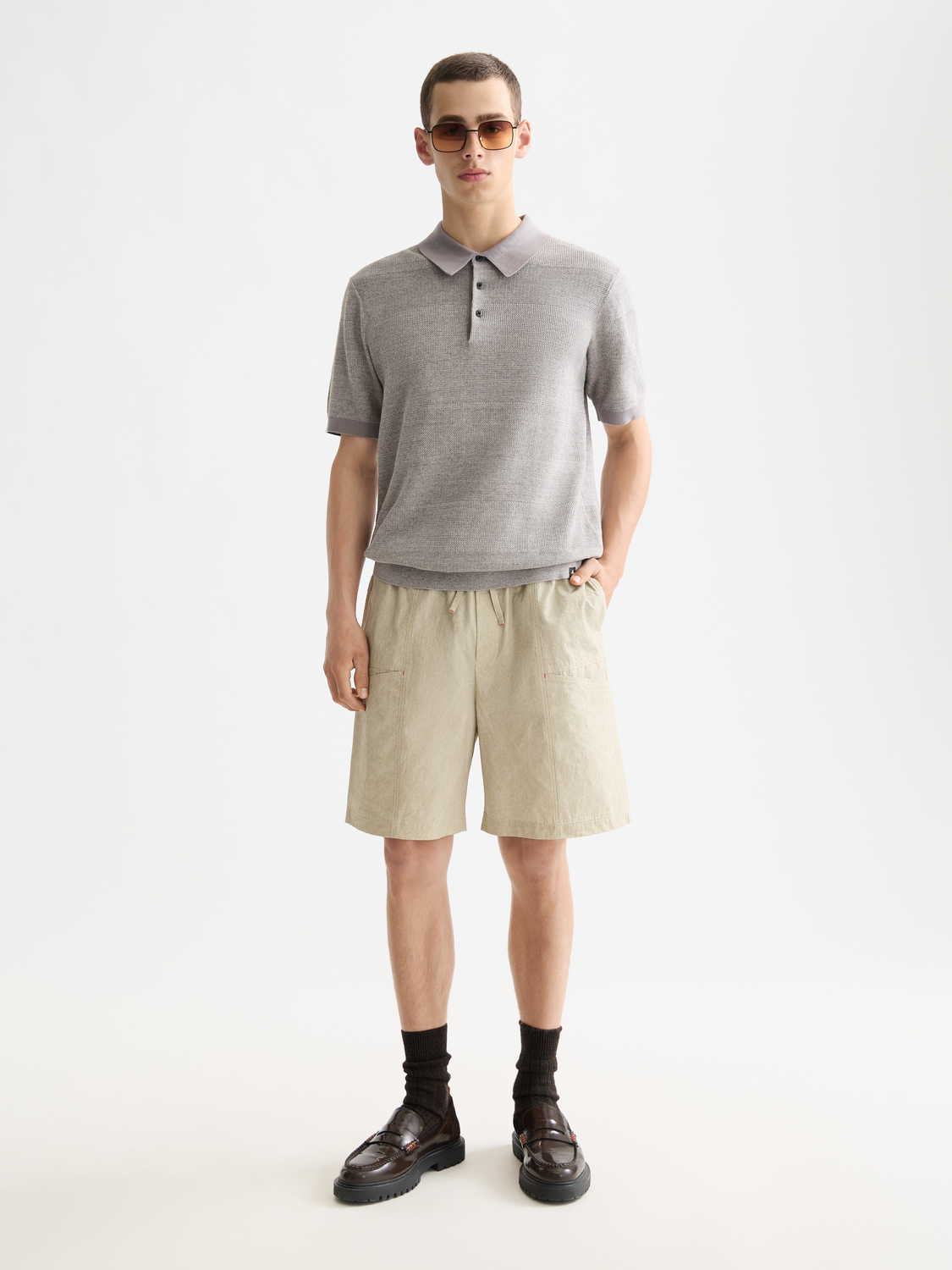 Knitted tonal striped polo shirt by Scotch & Soda featuring a classic collar and short sleeves, stylish and comfortable for casual wear.