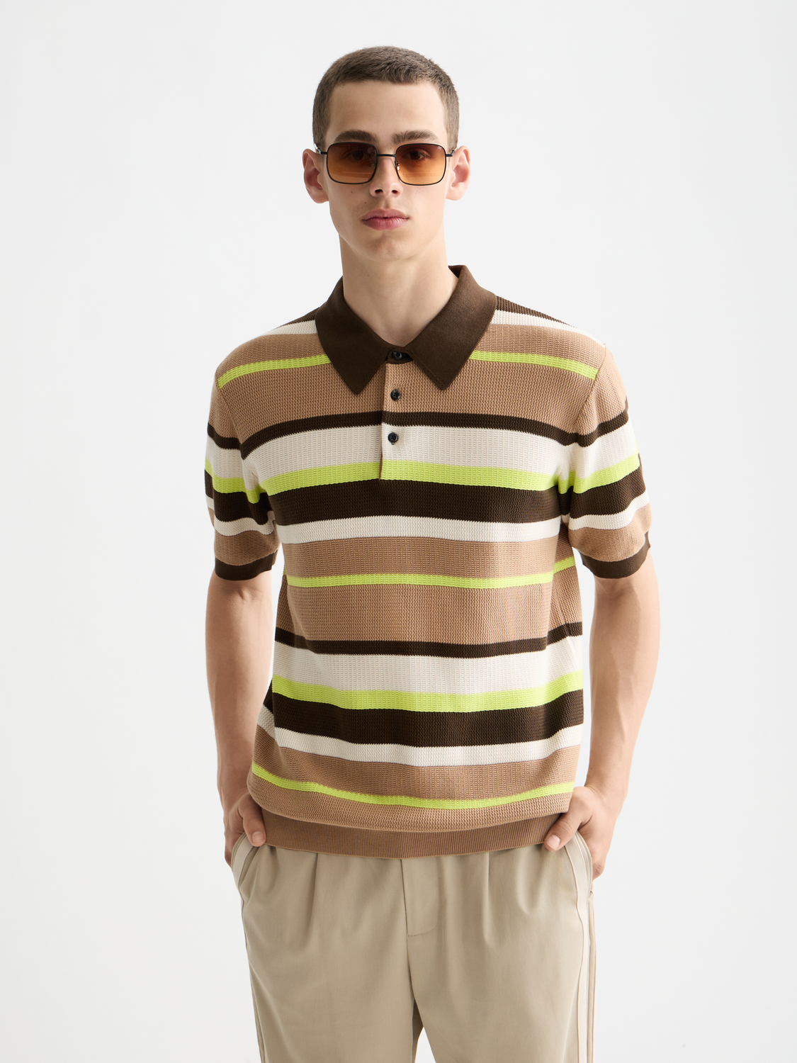Knitted striped polo shirt by Scotch & Soda featuring a classic collar, multicolor stripes, and short sleeves.