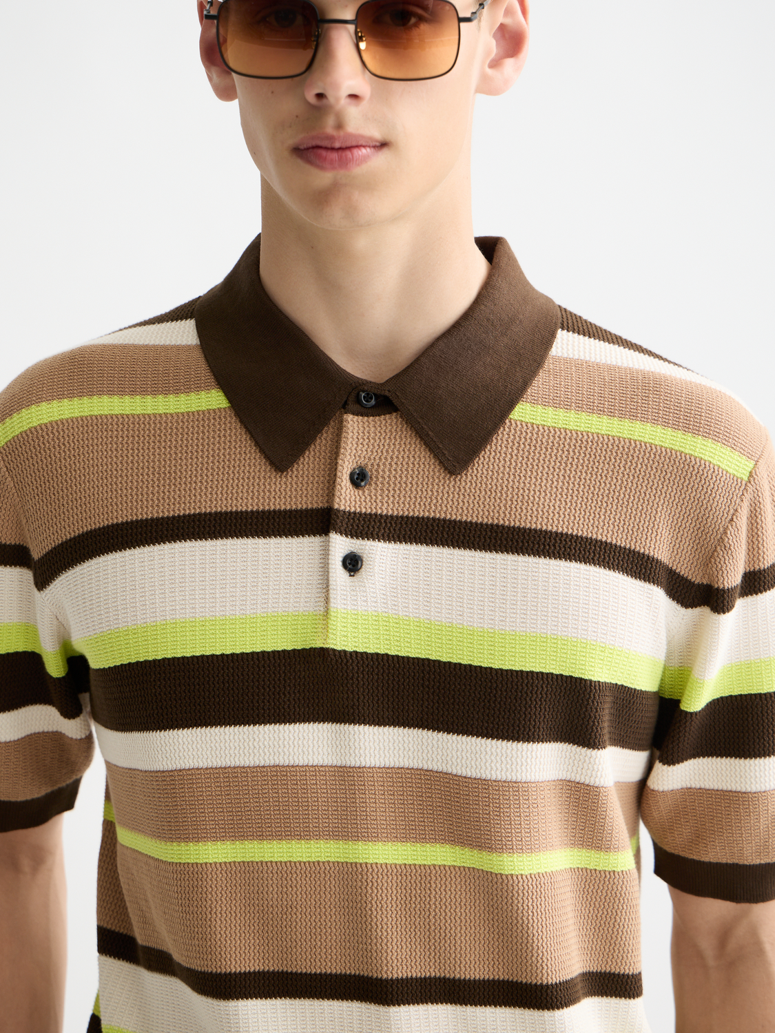 Knitted striped polo shirt by Scotch & Soda featuring a classic collar and multicolor horizontal stripes.