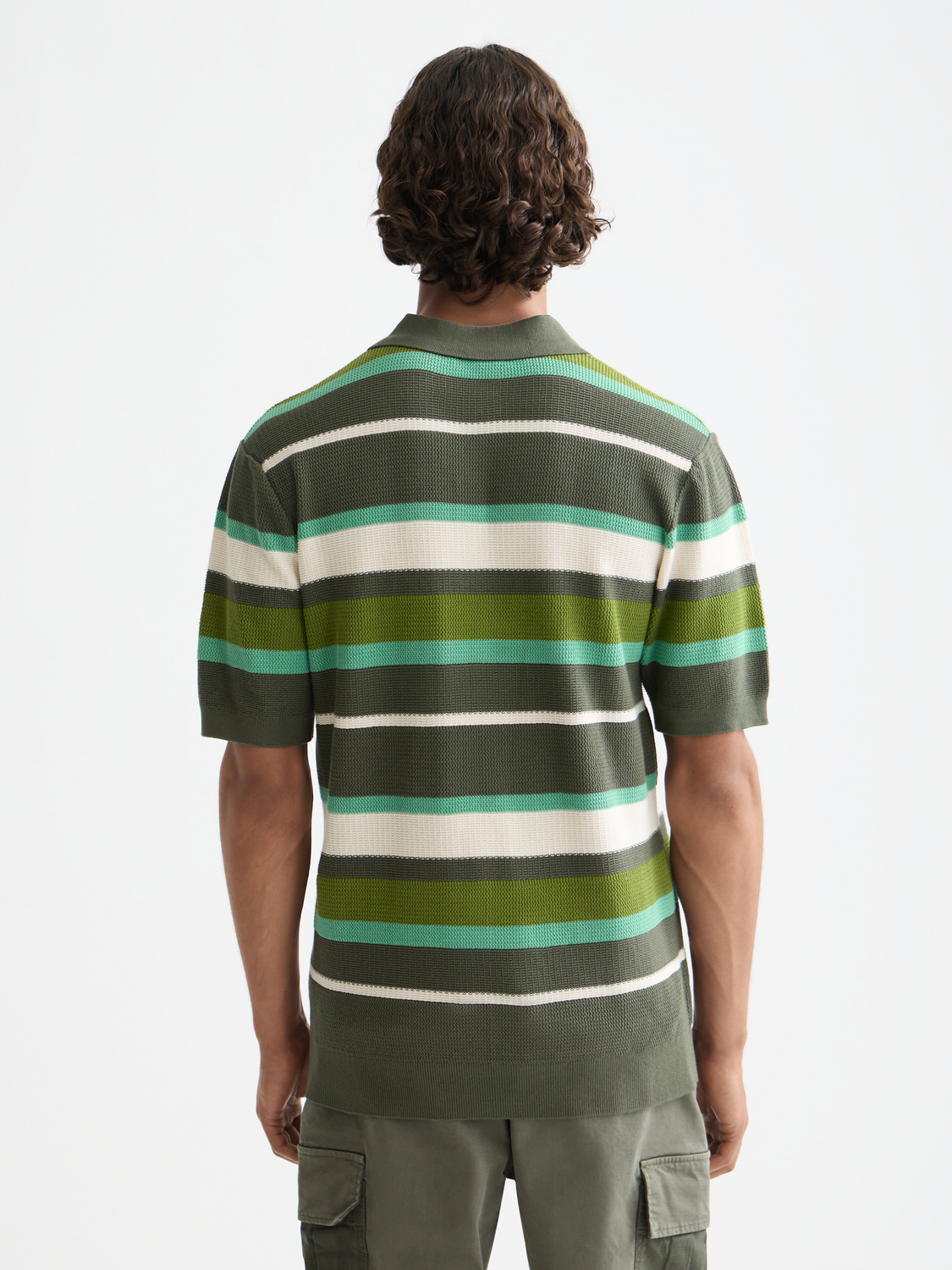 Knitted striped polo shirt by Scotch & Soda, featuring a classic collar, short sleeves, and multicolor horizontal stripes.
