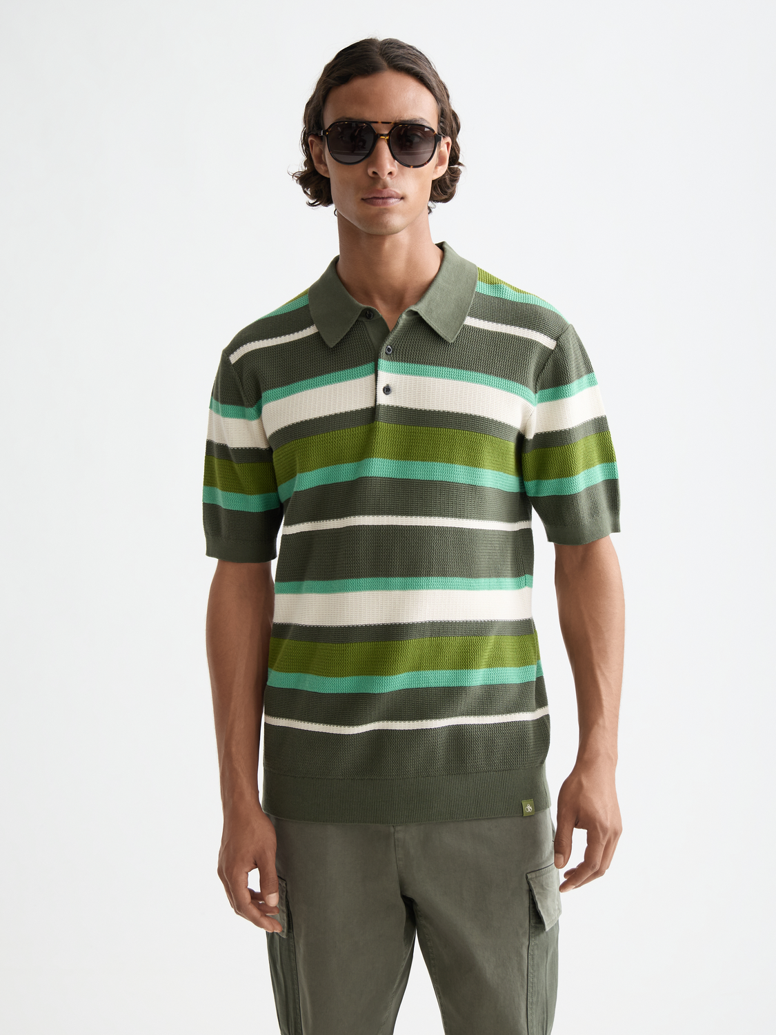 Knitted striped polo shirt from Scotch & Soda featuring a classic collar and multicolor horizontal stripes.