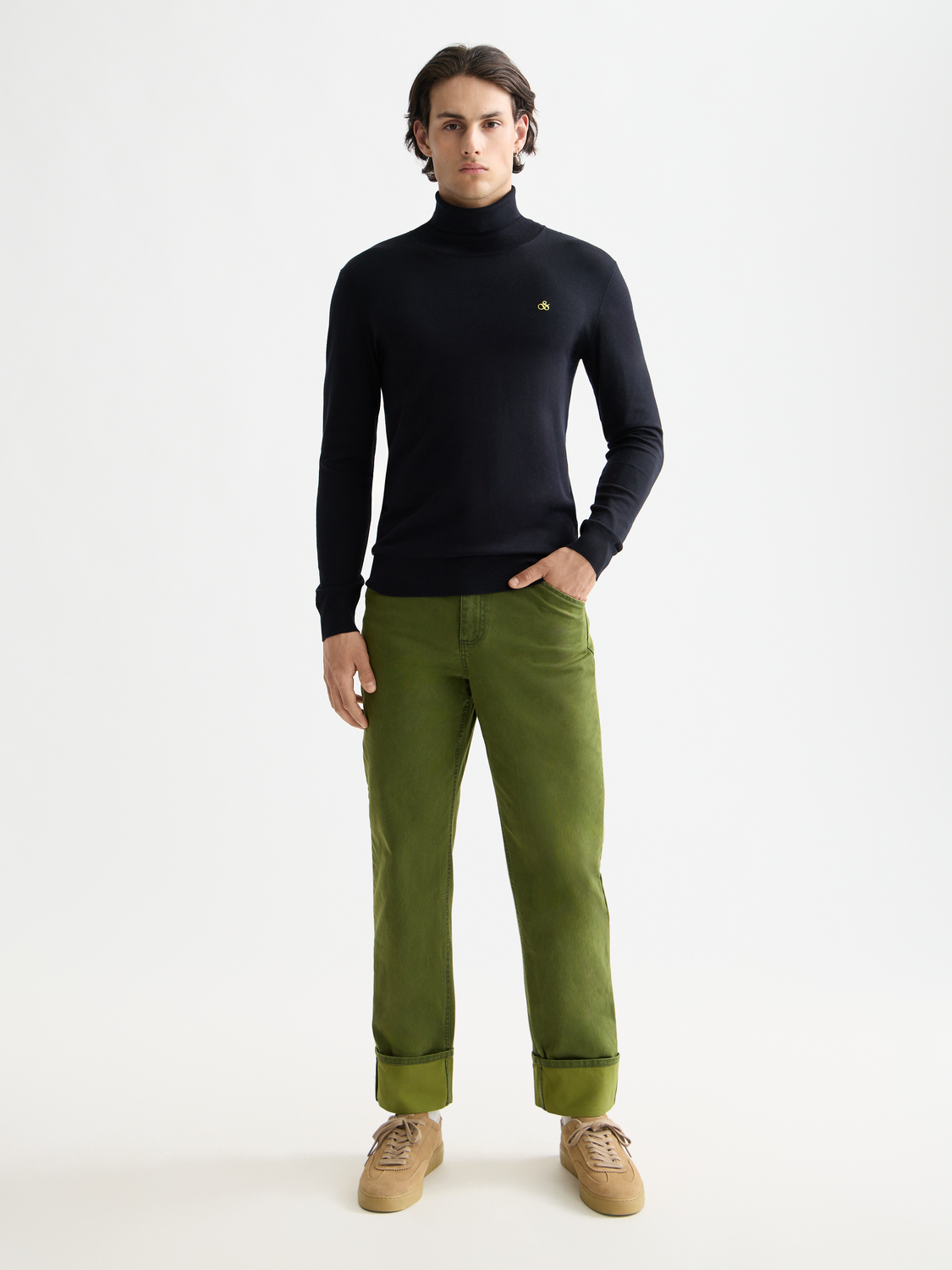 Navy knit turtleneck sweater by Scotch & Soda, showcasing a close-up of the soft, ribbed knit fabric and high neckline.
