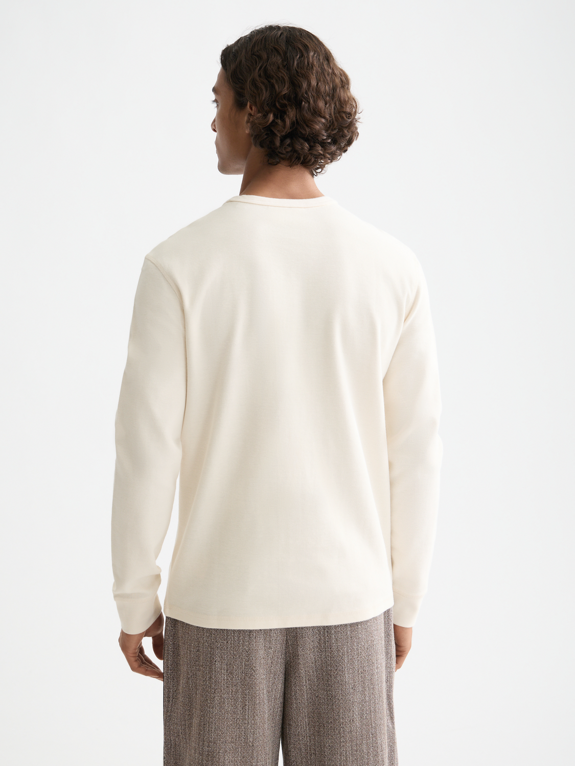 Long-sleeved waffle t-shirt by Scotch & Soda in a dark color, featuring a textured fabric and casual fit.
