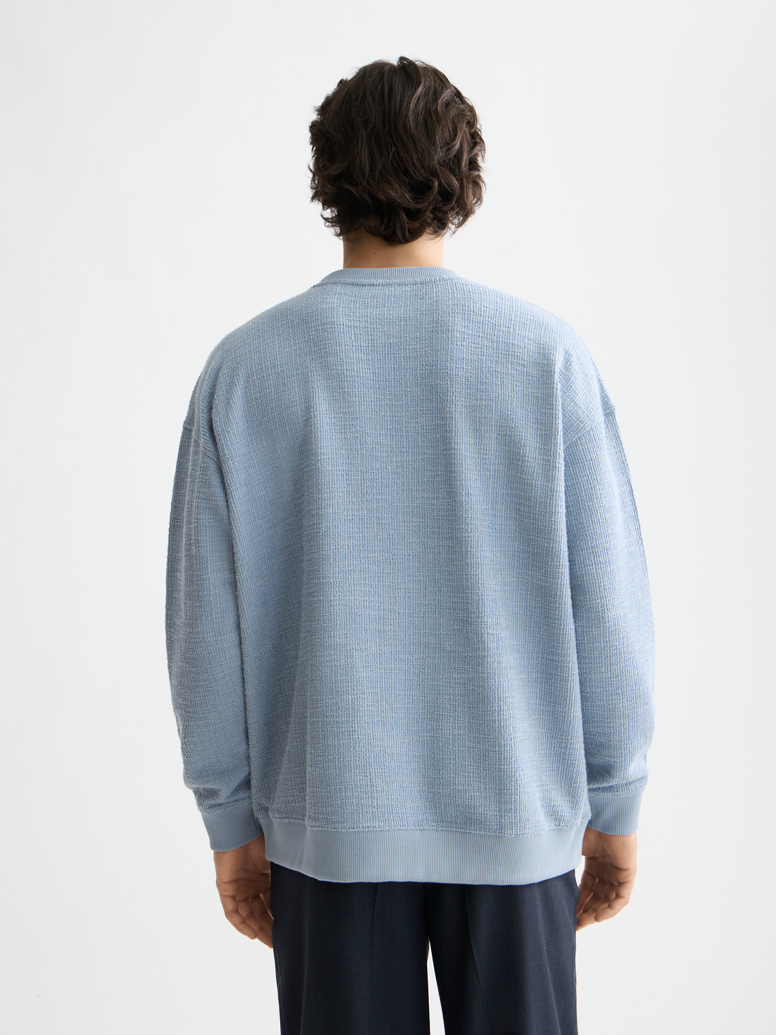 Textured SCOTCH & SODA sweatshirt with long sleeves and crew neckline, shown in black on a plain background.