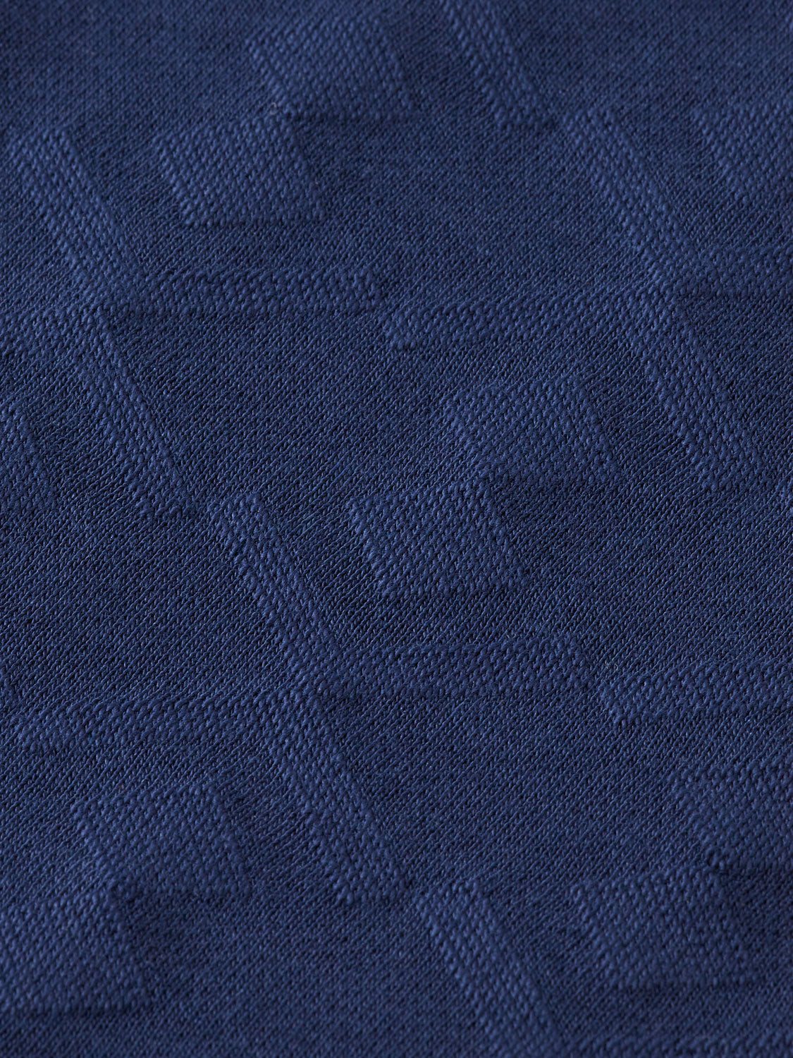 Jacquard terry sweatpants by Scotch & Soda, showing a relaxed fit with a textured pattern and elastic waist.