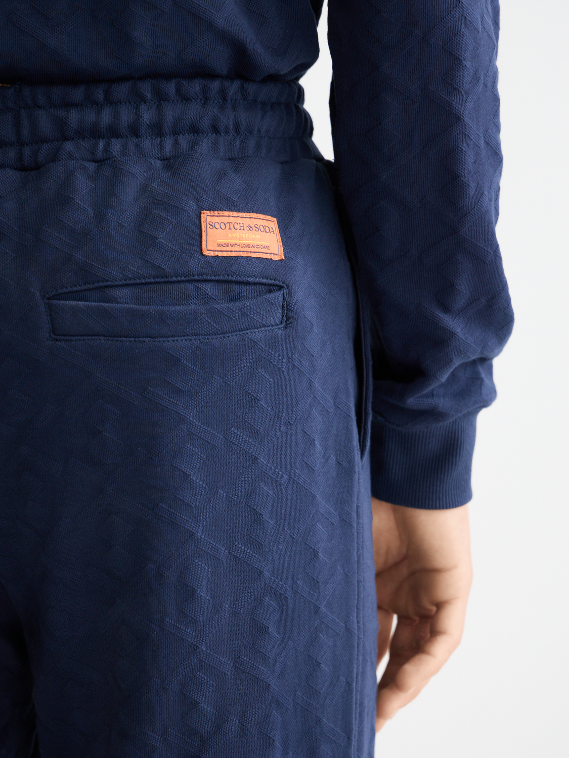 Scotch & Soda jacquard terry sweatpants in neutral color, featuring a relaxed fit and detailed textured pattern.