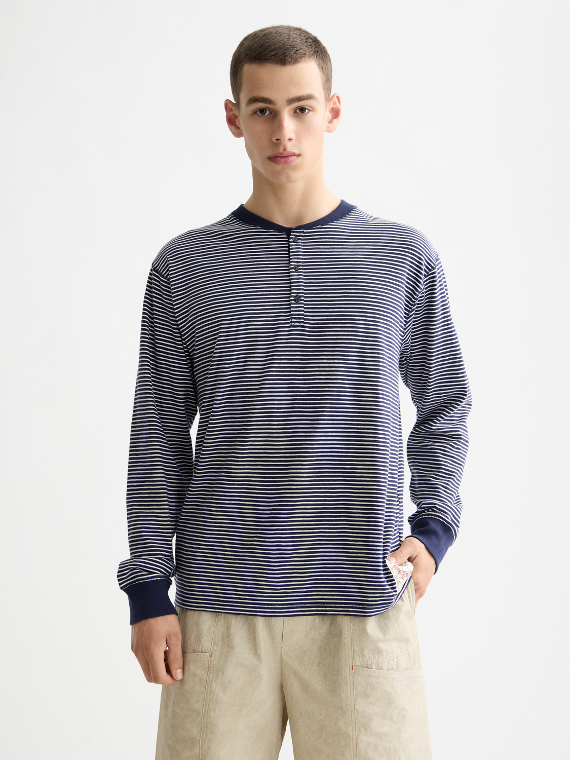 Long sleeve striped Henley t-shirt by SCOTCH & SODA with a buttoned collar and casual fit, shown in a front view.