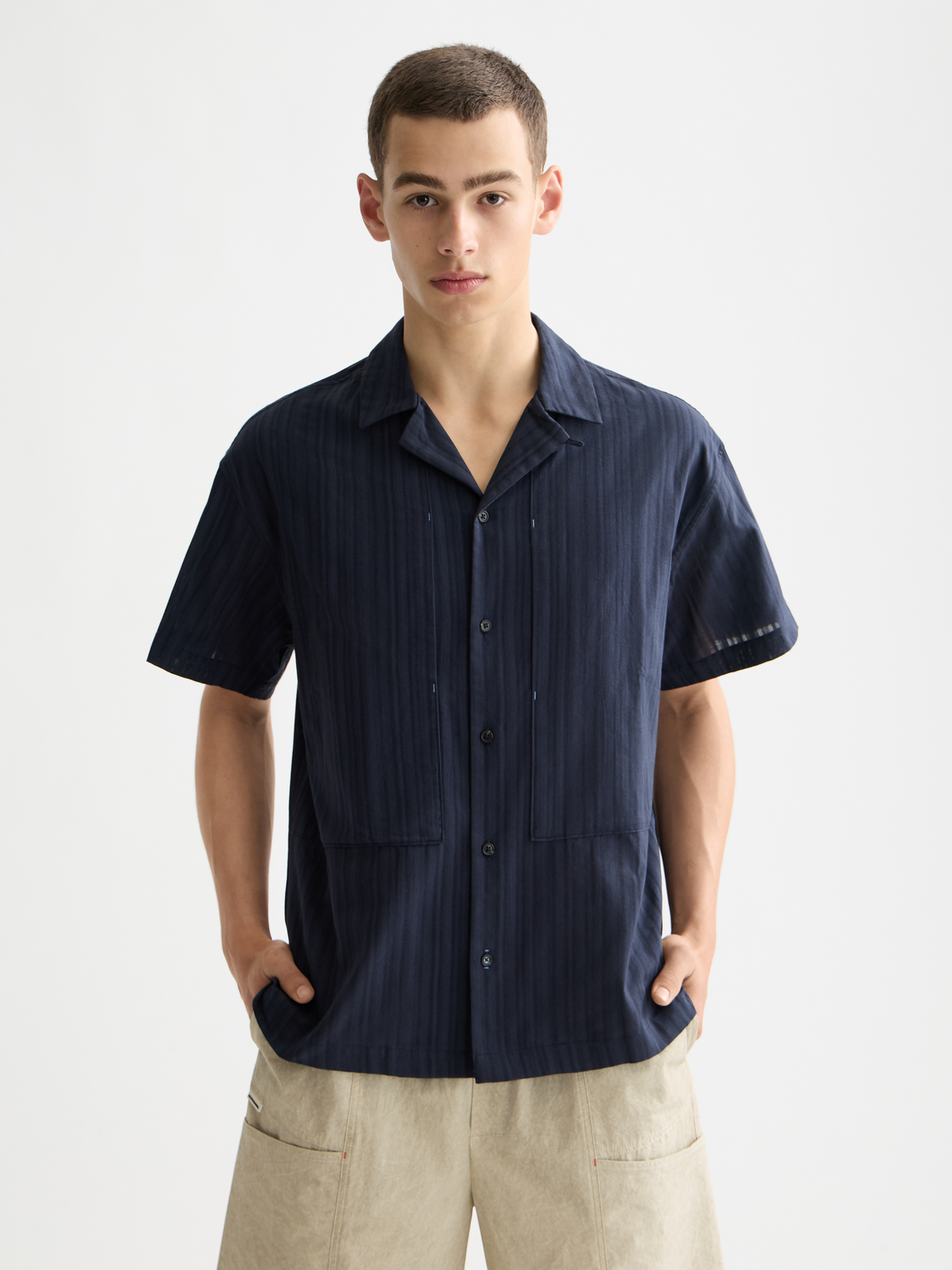 Striped short-sleeved shirt by Scotch & Soda, featuring a casual fit and bold stripe pattern, front view with collar and button detail.