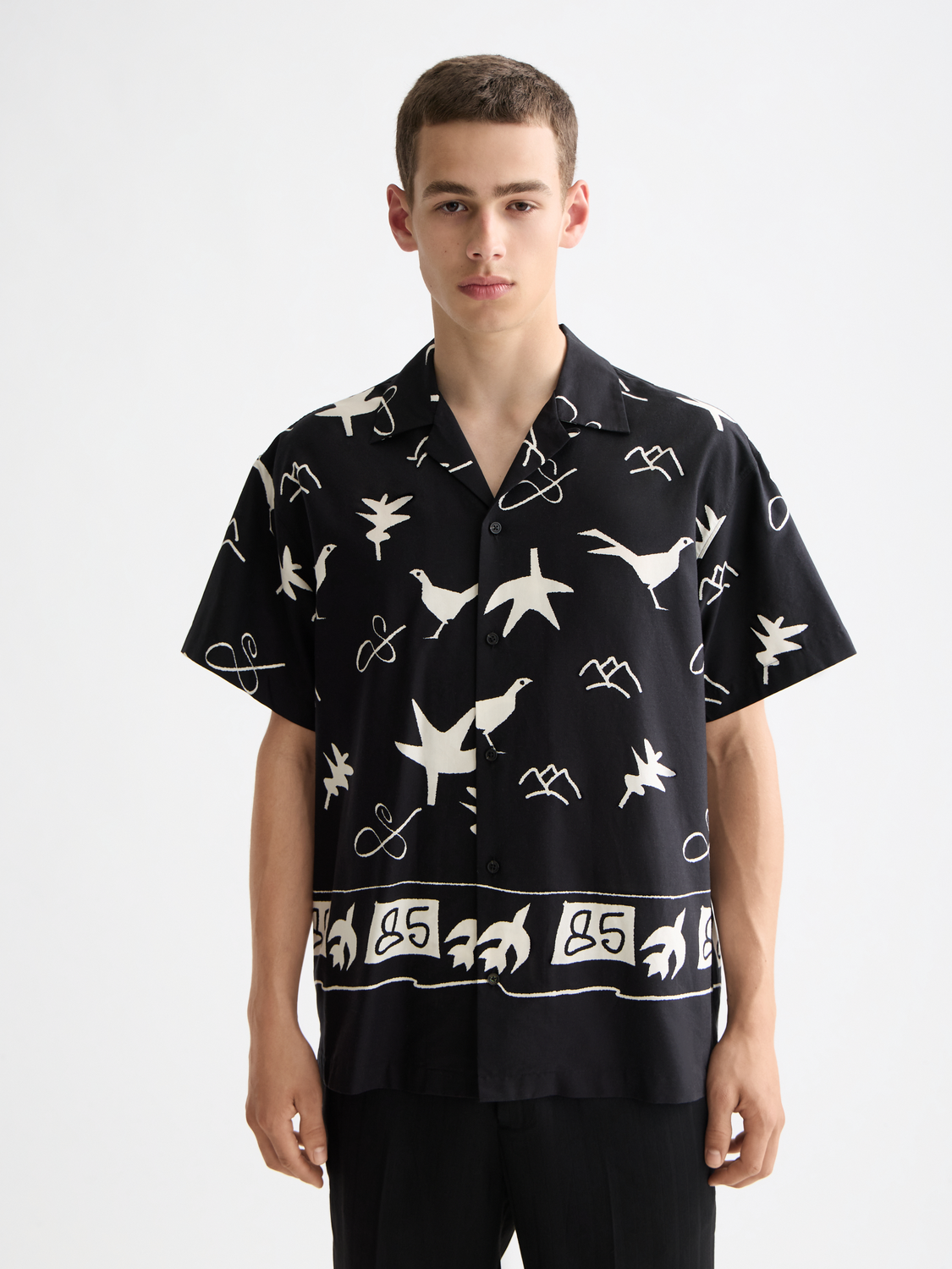 Short-sleeved shirt by Scotch & Soda featuring a colorful front print and casual fit.