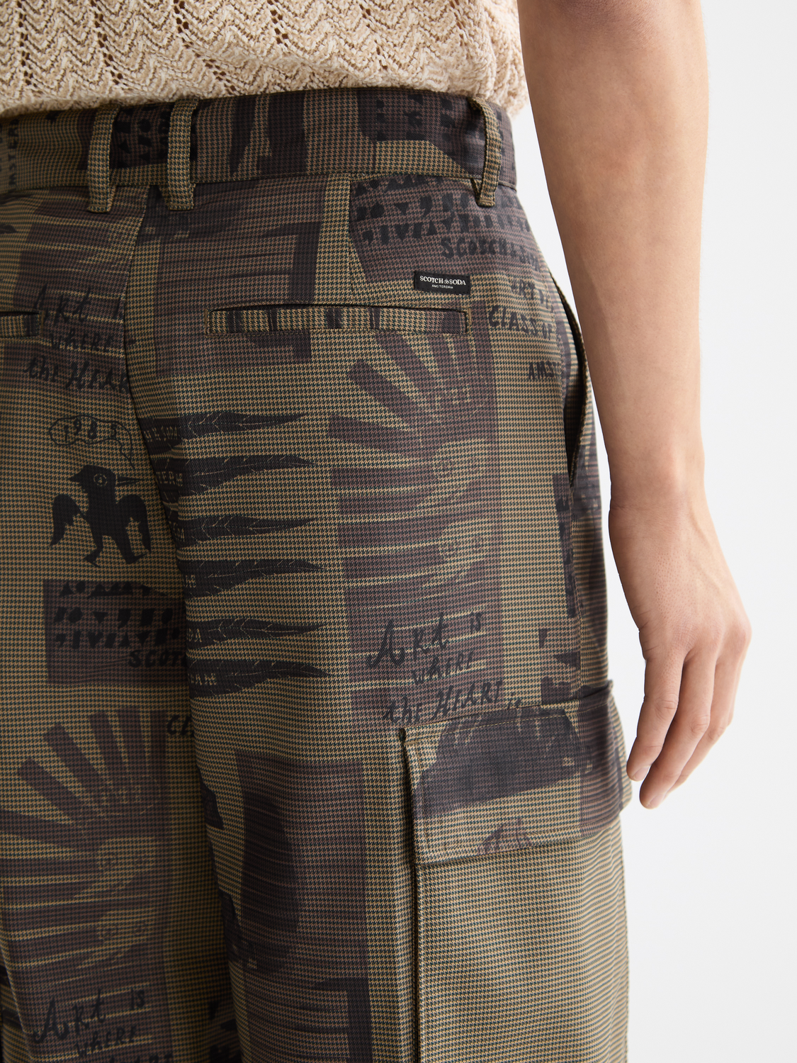 Printed cargo pants by Scotch & Soda featuring multiple pockets, relaxed fit, and stylish pattern for casual wear.