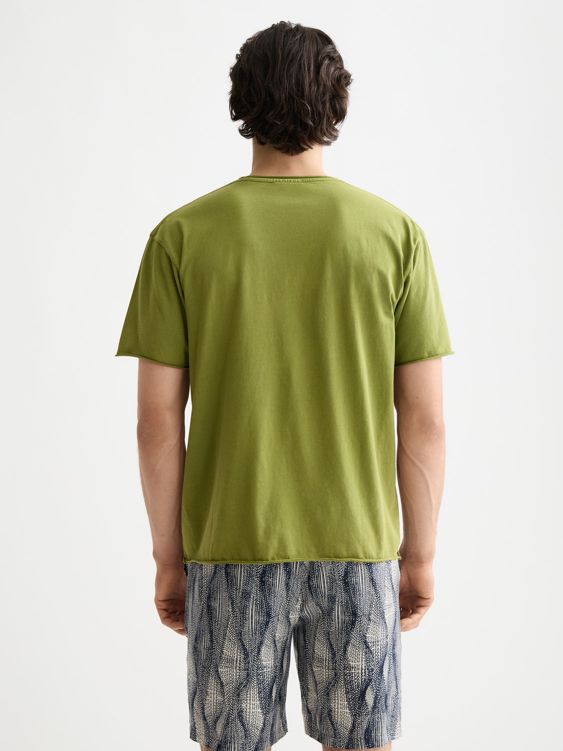Short-sleeve Scotch & Sodas raw edge t-shirt with distressed hem, black color, casual style, shown from the back.