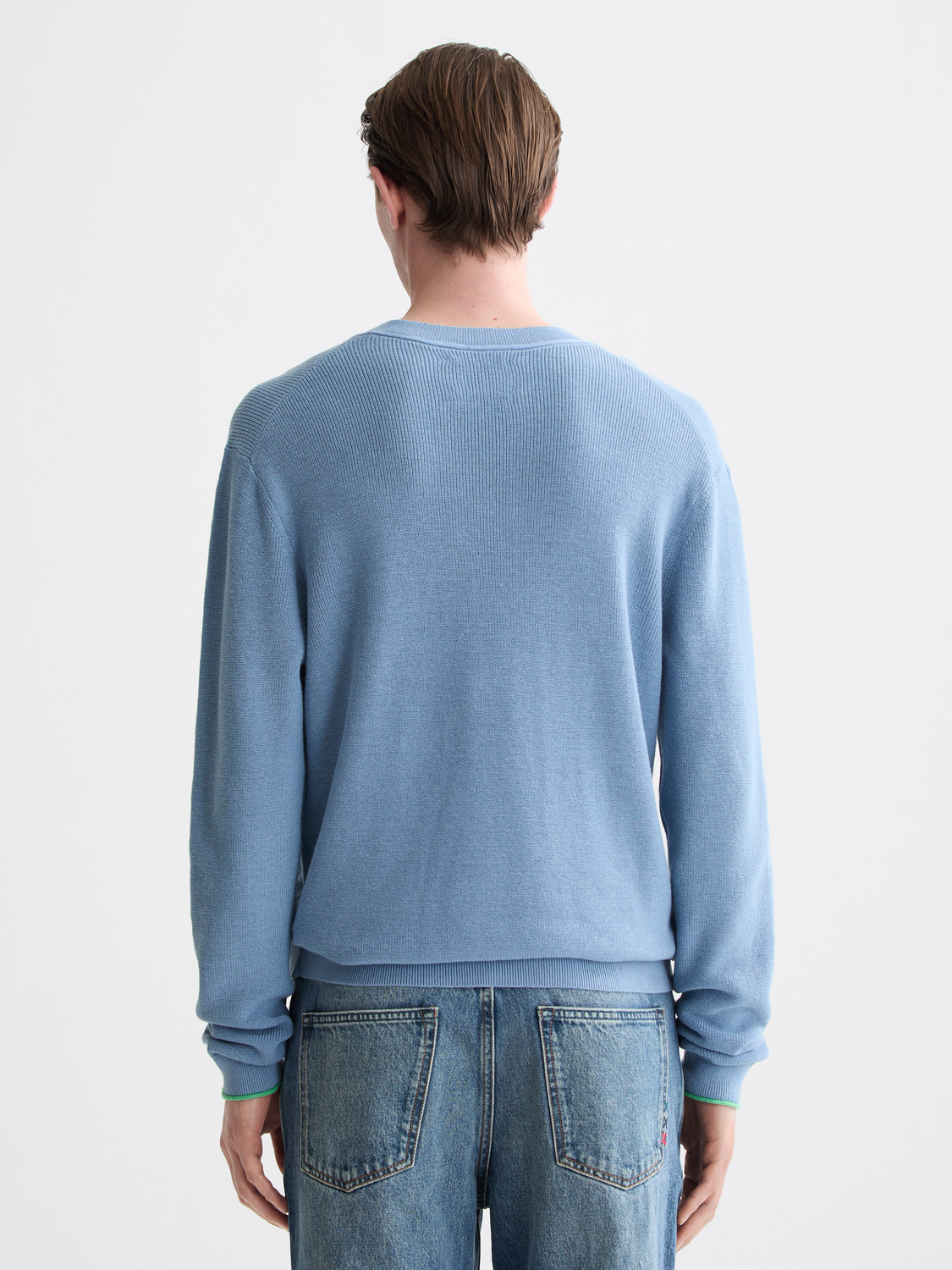 Navy V-neck knitwear pullover by Scotch & Soda with ribbed cuffs and hem, front view showing smooth knit texture.