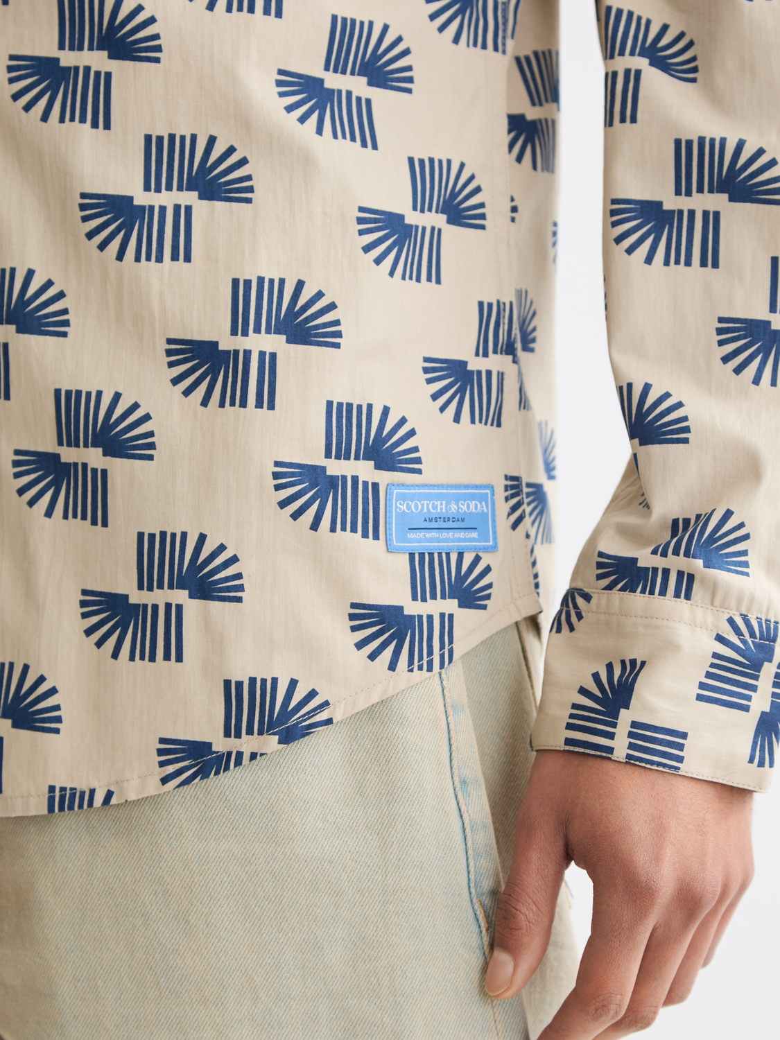 Long sleeve printed shirt by Scotch & Soda featuring vibrant patterns and casual fit, displayed on a hanger.